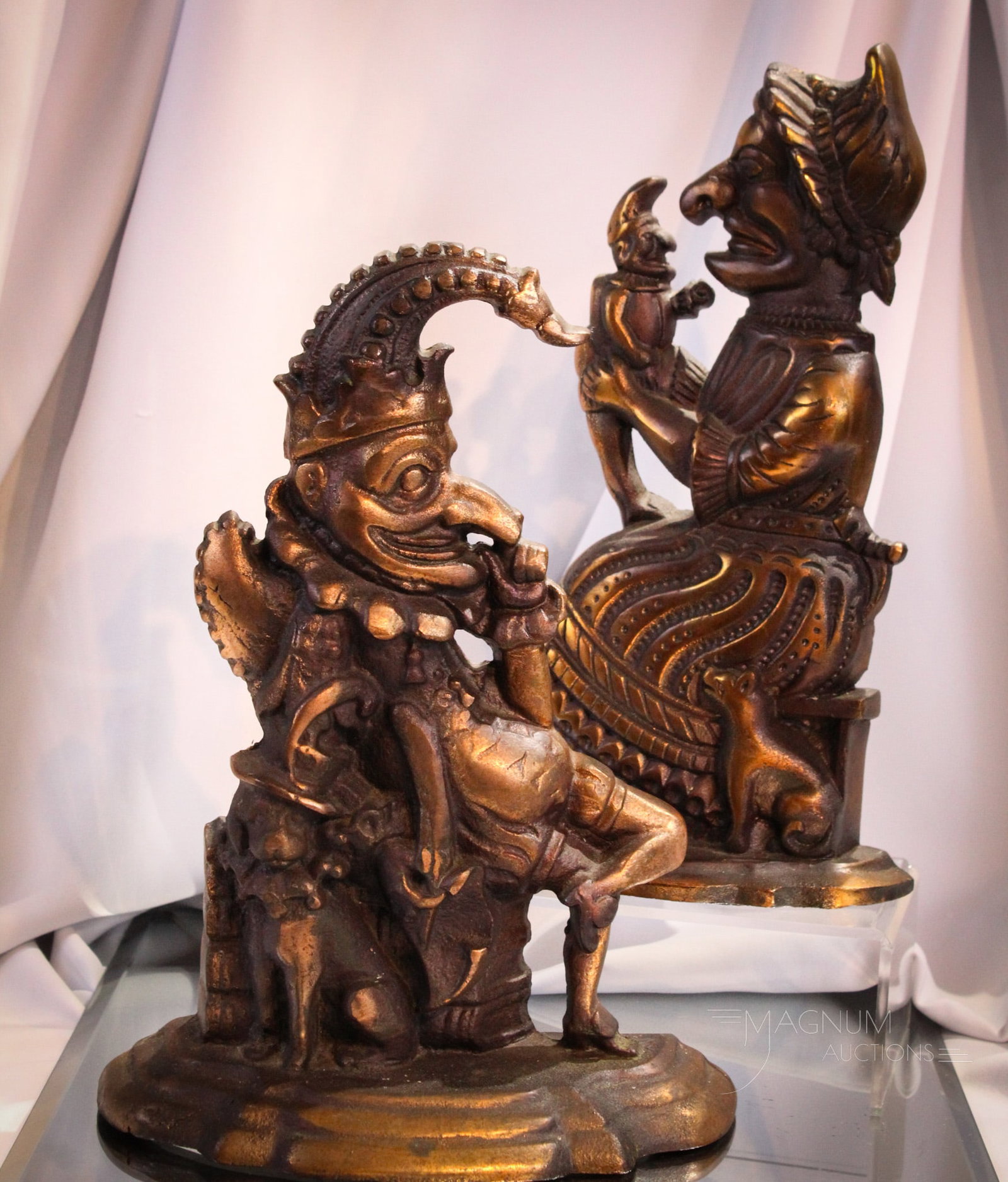 Pair Punch & Judy Cast Iron Antique Door Stops: Fine pair of matching patina in copper cast iron early Punch & Judy door stops. Each quite nice and tallest measuring 12".