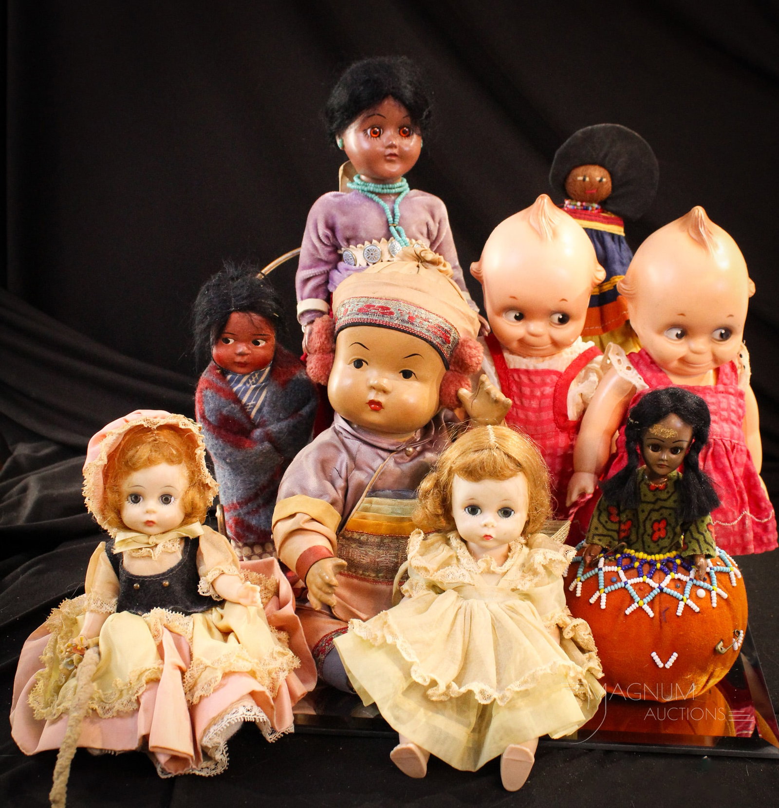 9 pc Lot Kewpie Madame Alexander & More Dolls: Nine examples of collectible dolls including two Kewpies and Madame Alexander examples and so much more. Largest measures 11".