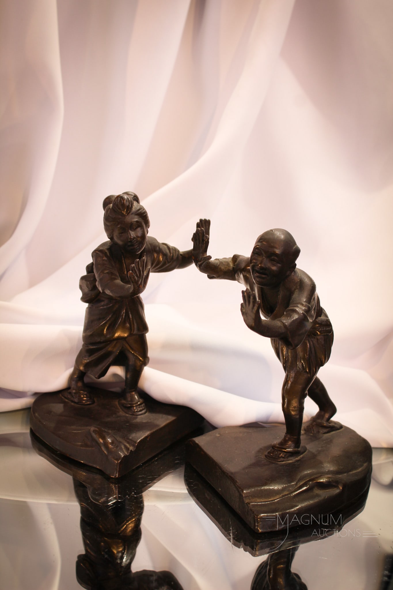 Pair Bronze Over Plaster Antique Figural Oriental Bookends: Pair of figural bronze over plaster antique bookends. Pair are oriental figural man and woman. Tallest measures 7 1/2" tall.