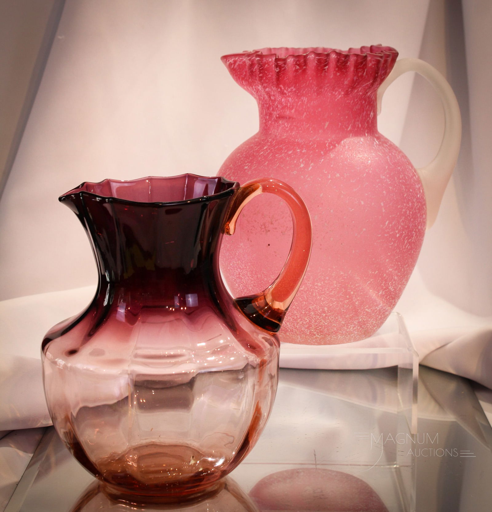 2 pc Lot Victorian Northwood Bohemian Glass Ombre' Water Pitchers: One as nice as the next! A wonderful amythest shaded to pink ombre' Victorian pitcher of Bohemian origin. This along with a Northwood cranberry granite ware finish decoration example. Tallest measures