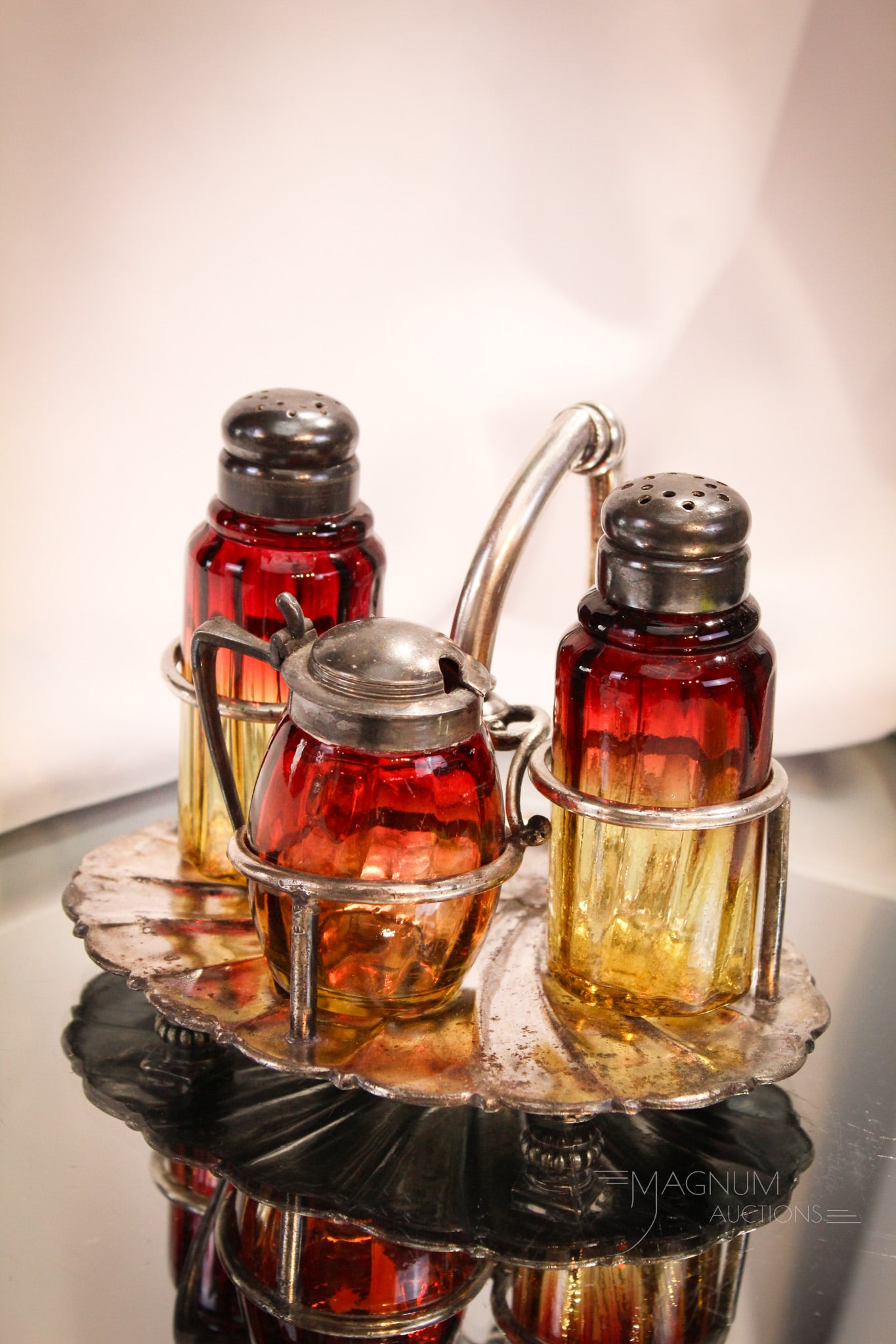 Meriden Silverplate Victorian Amberina Shaker Condiment Set: Superb three piece Victorian amberina Rib Optic pattern condiment set in a signed Meriden silverplate Victorian holder. Complete set measrues 4 1/2" tall.