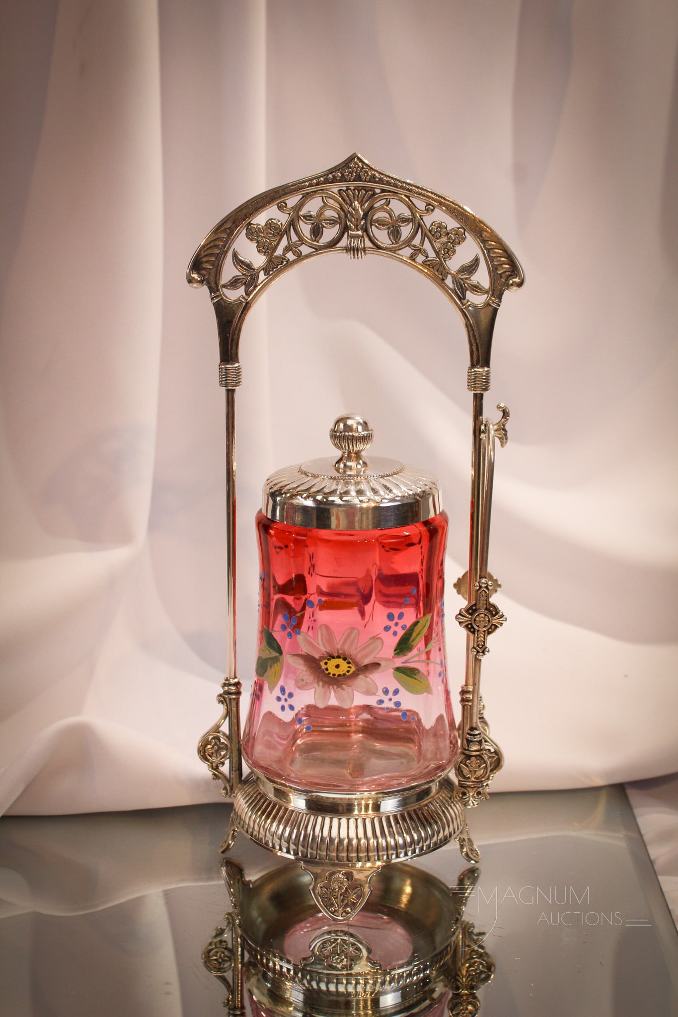 Derby Silverplate Victorian Cranberry Enameled Pickle castor: So much to love about this fine offering of a Victorian pickle castor. This ornate frame is signed Derby silverplate. Jar is wonderful cranberry rubina enameled with flowers. Measures 12" tall.