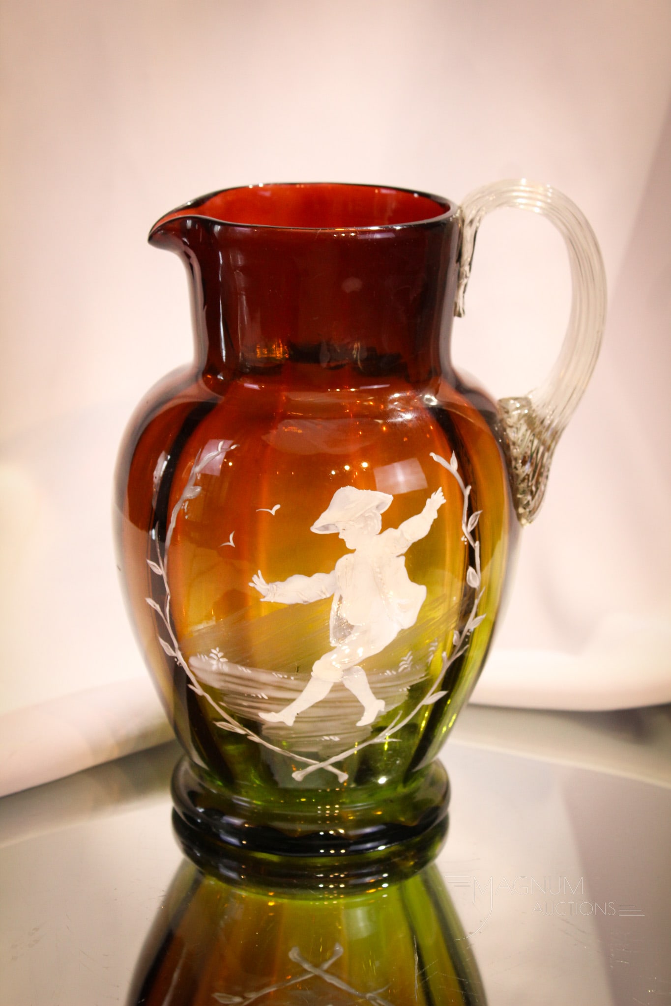 Mary Gregory Enameled Victorian Amberina to Green Water Pitcher: Marvelous deep rich amberina to green coloring on this Victorian Mary Gregory enameled decoration Victorian pitcher. Pitcher has applied clear reeeded handle. It measures 8" tall.