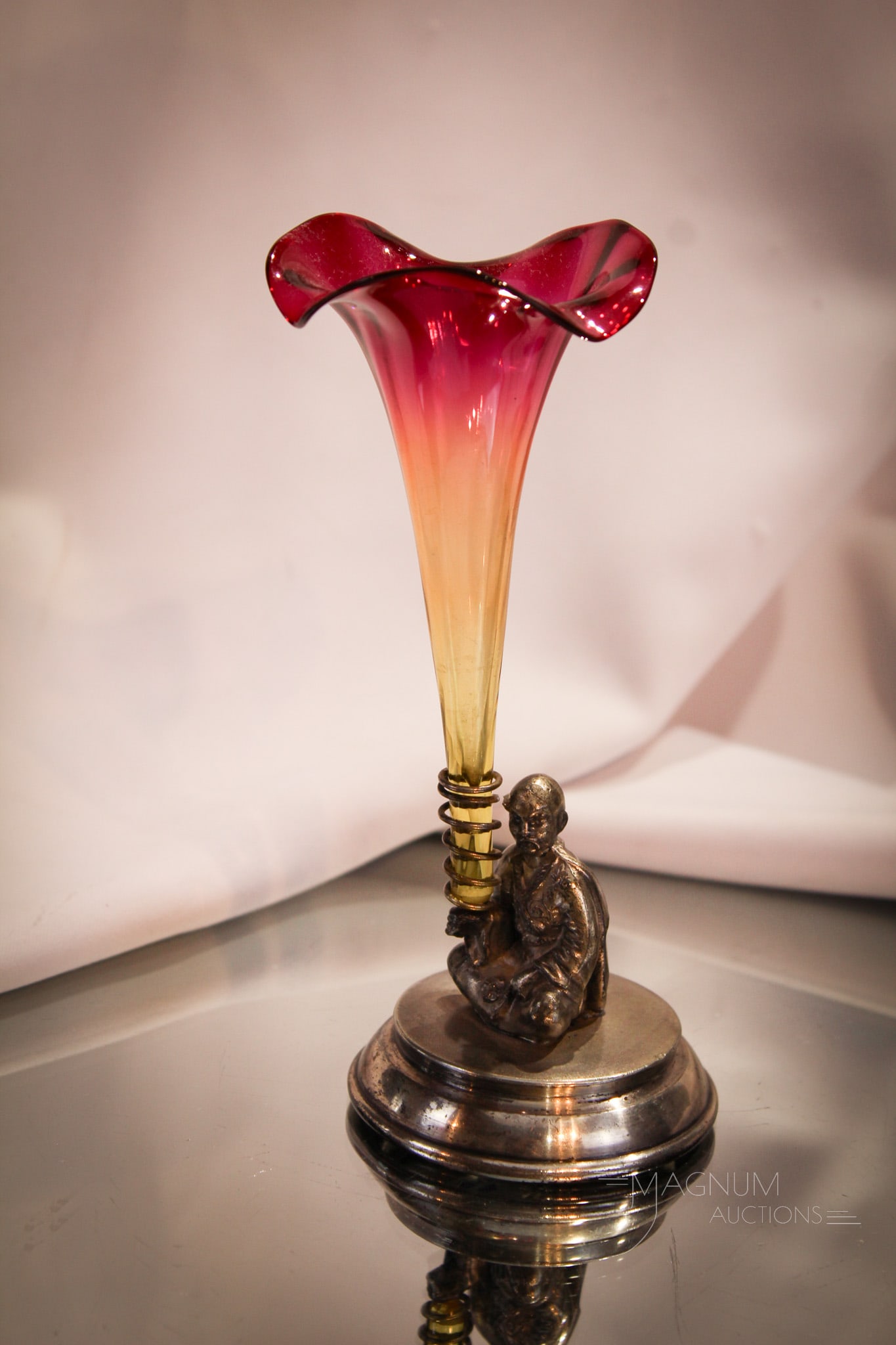 Pairpoint Silverplate Victorian Figural Amberina Bud Vase: Signed Victorian Pairpoint silverplate oriental man seated holding an amberina lily vase. Complete it measures 6 3/4" tall.