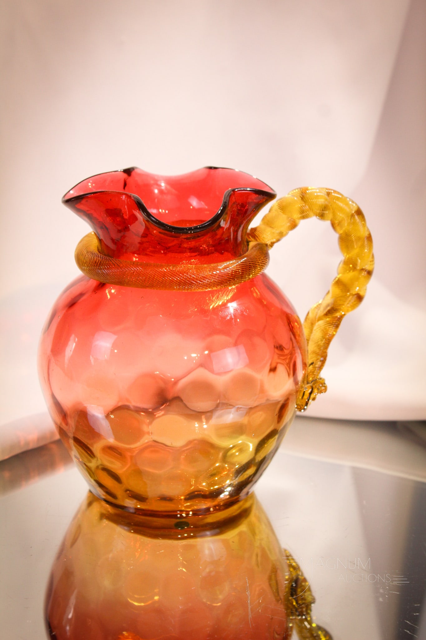 Victorian Amberina Rope Handle Glass Milk Pitcher: Great example of a Victorian amberina milk size pitcher with rope twisted handle. Nice coloring and size make this a stand out piece! It measures 6" tall.
