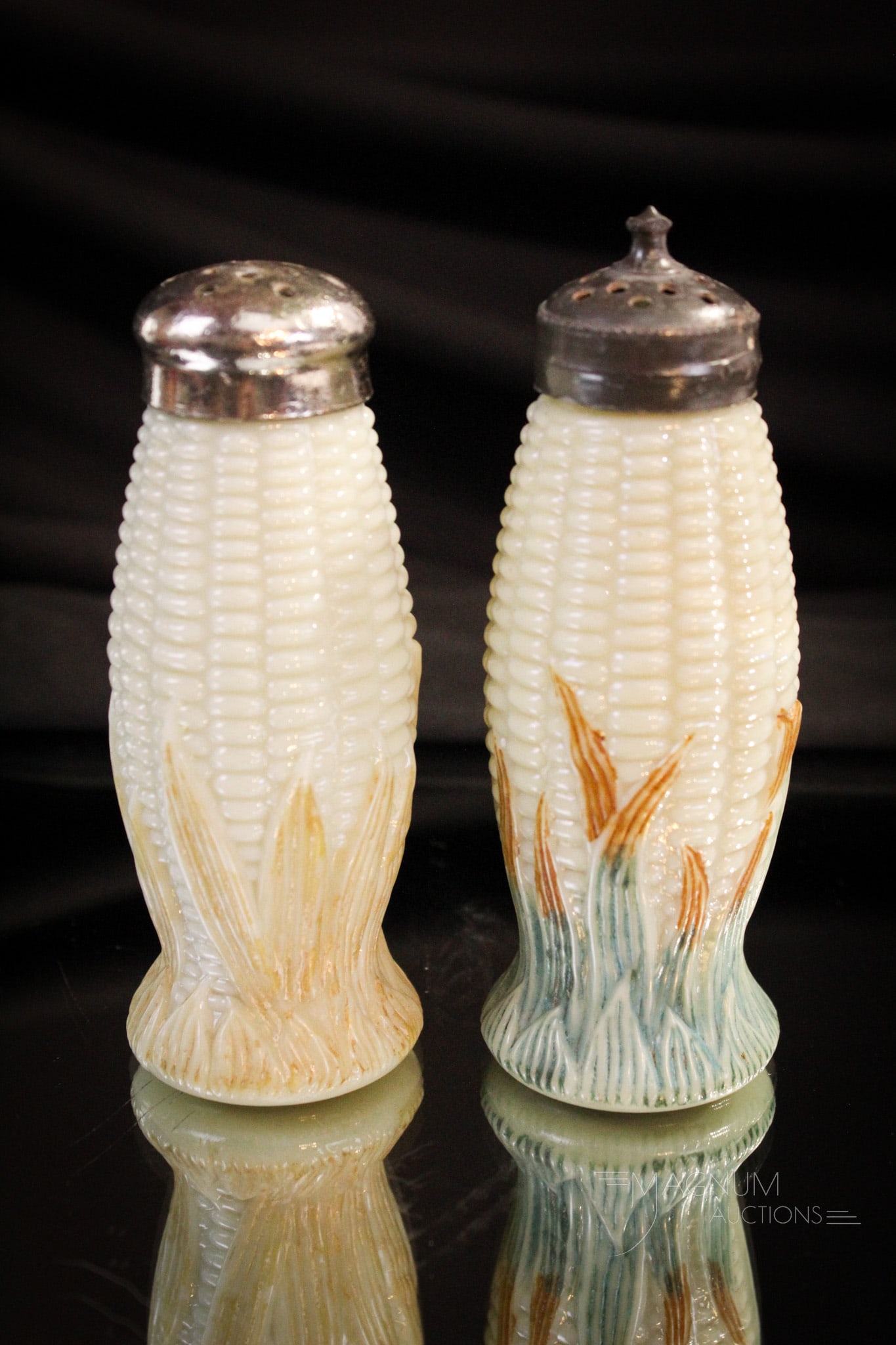2 pc Lot Libbey Maize Corn Cob Victorian Custard Glass Shakers: Two fine examples of Libbey Maize pattern Victorian salt shakers in decorated custard glass. One with brown husks. One with green/brown husks. Each measures 4" tall.