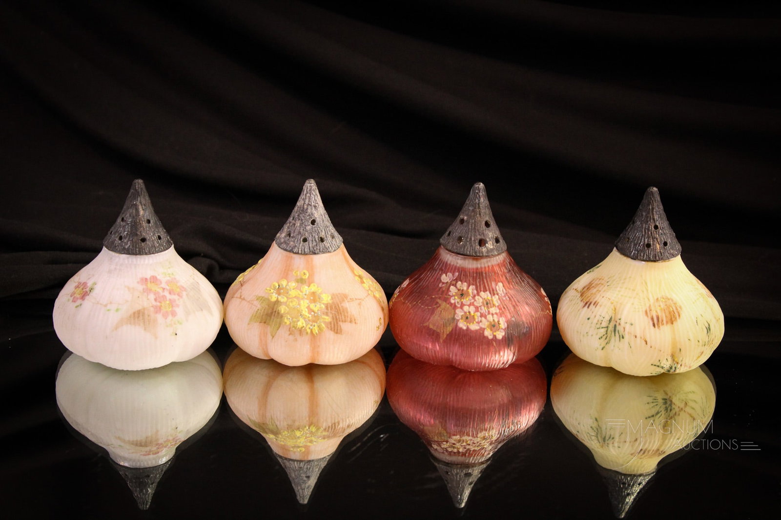 4 pc Lot Mt. Washington Glass Fig Family of Shakers: Nice starter set of Victorian Mt. Washington fig form salt shakers. Three in floral decorated opal glass. One in cranberry satin with florals. Each as nice as the next. Each measures 2 1/2" tall.