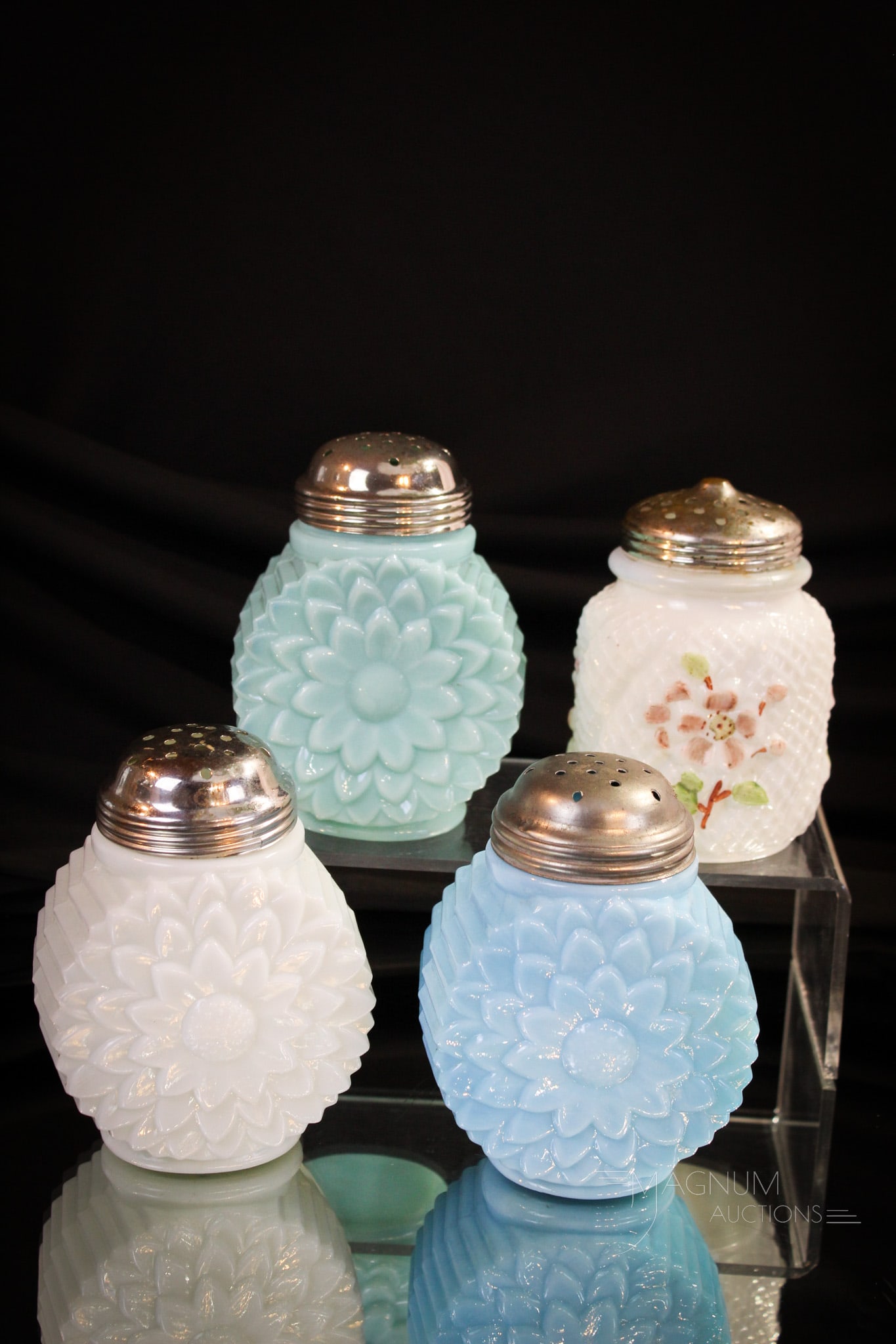 4 pc Lot Northwood Victorian Glass Sugar Shakers: Four fine examples of Victorian sugar shakers made by Northwood. Three select colors of Flat Flower pattern shakers along with a fan favorite Netted Apple Blossom. Tallest measures 4 1/2".