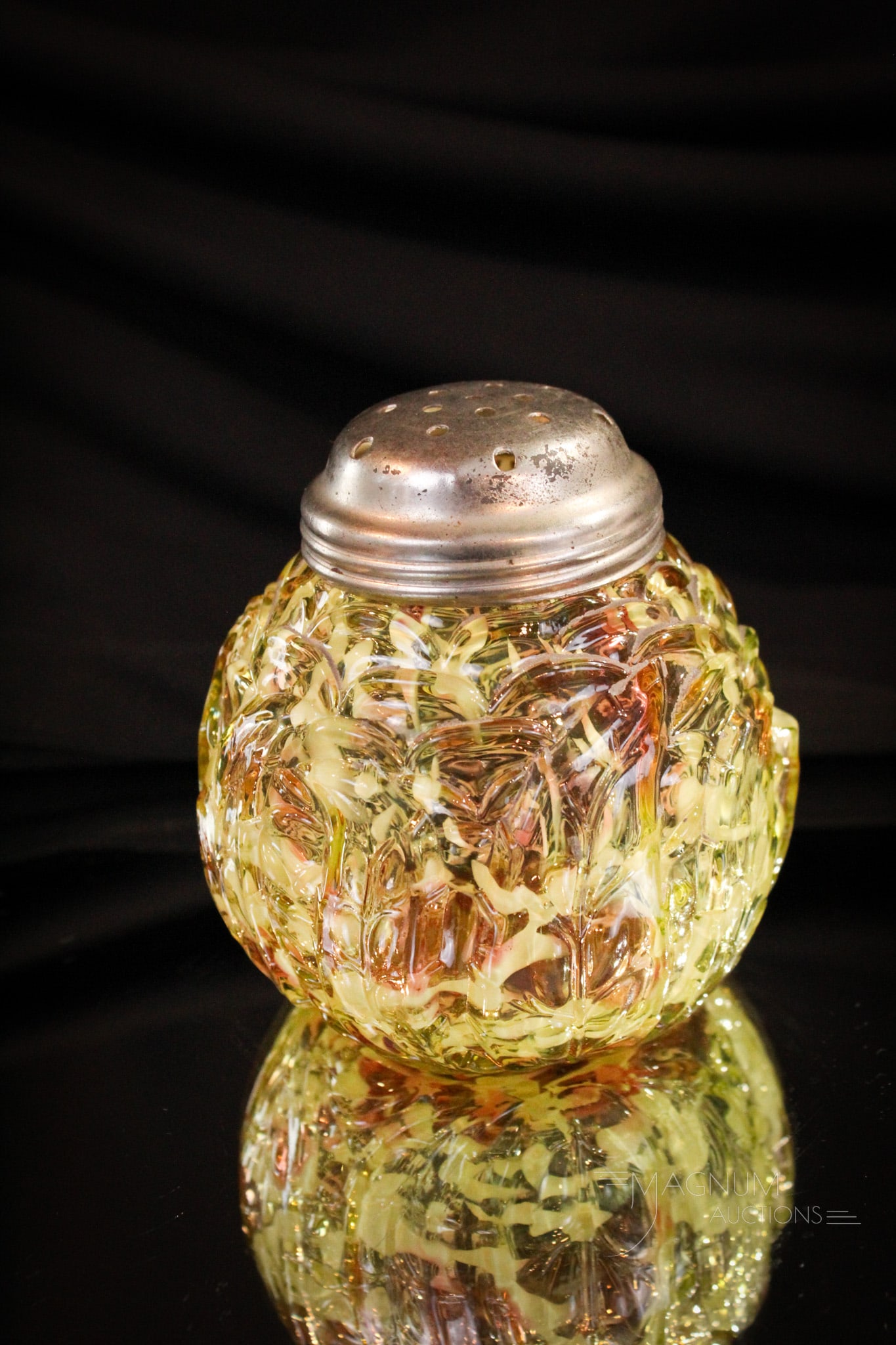 Northwood Vaseline Cranberry Spatter Leaf Mold Sugar Shaker: A fan favorite among the collectors, this Leaf Mold Victorian sugar shaker is always a welcome addition to any collection. This one with nice coloring and spatter effect. It stands 3 1/2" tall.