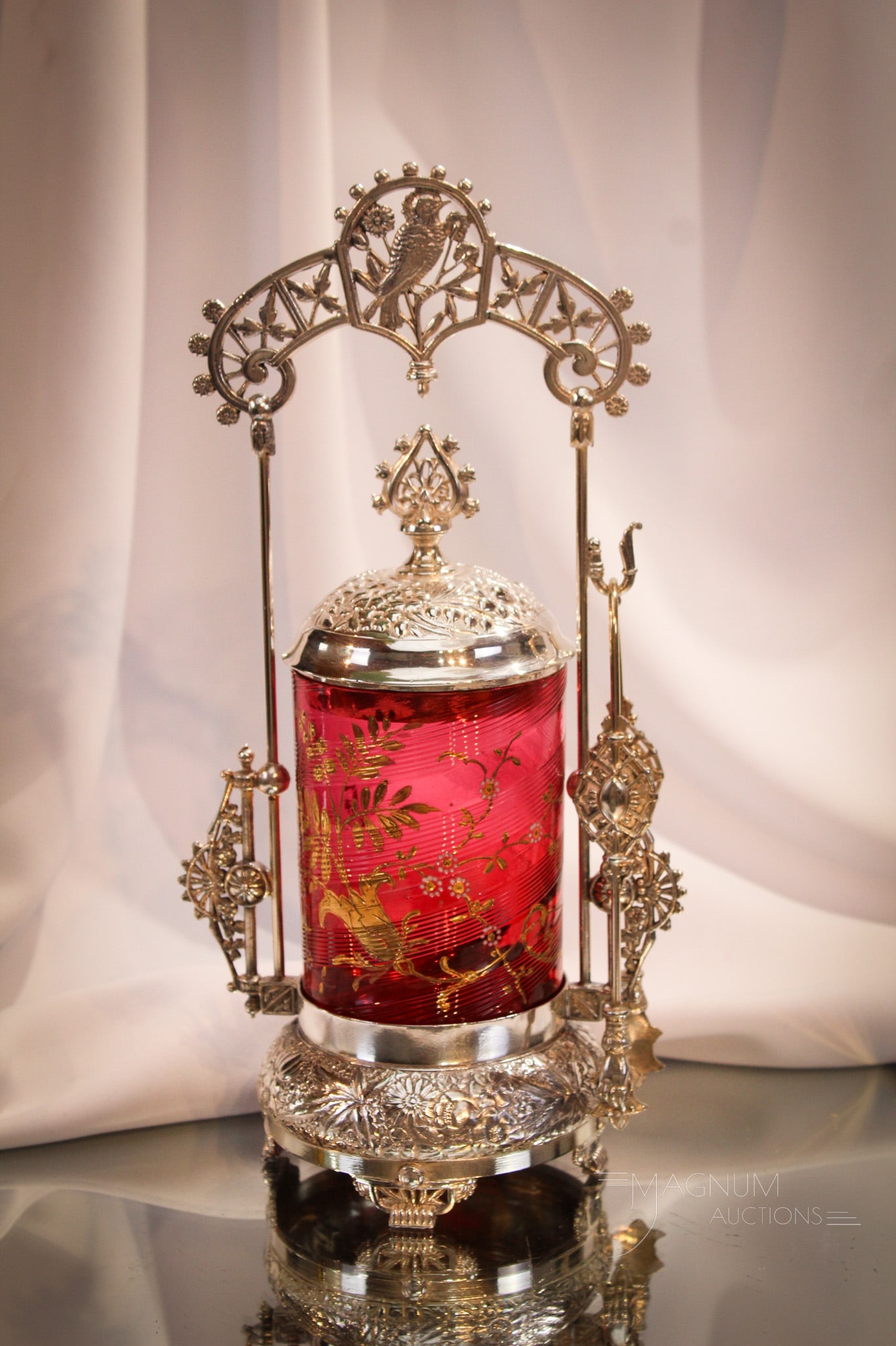 Meriden Victorian Silverplate Cranberry Gilt Decorated Pickle Castor: Lovely ornate Victorian signed Meriden silverplate pickle castor. Piece is complete with cranberry swirled insert adorned with gilt florals. Lovely piece, dear. It measures 12 1/2" tall to the top of 