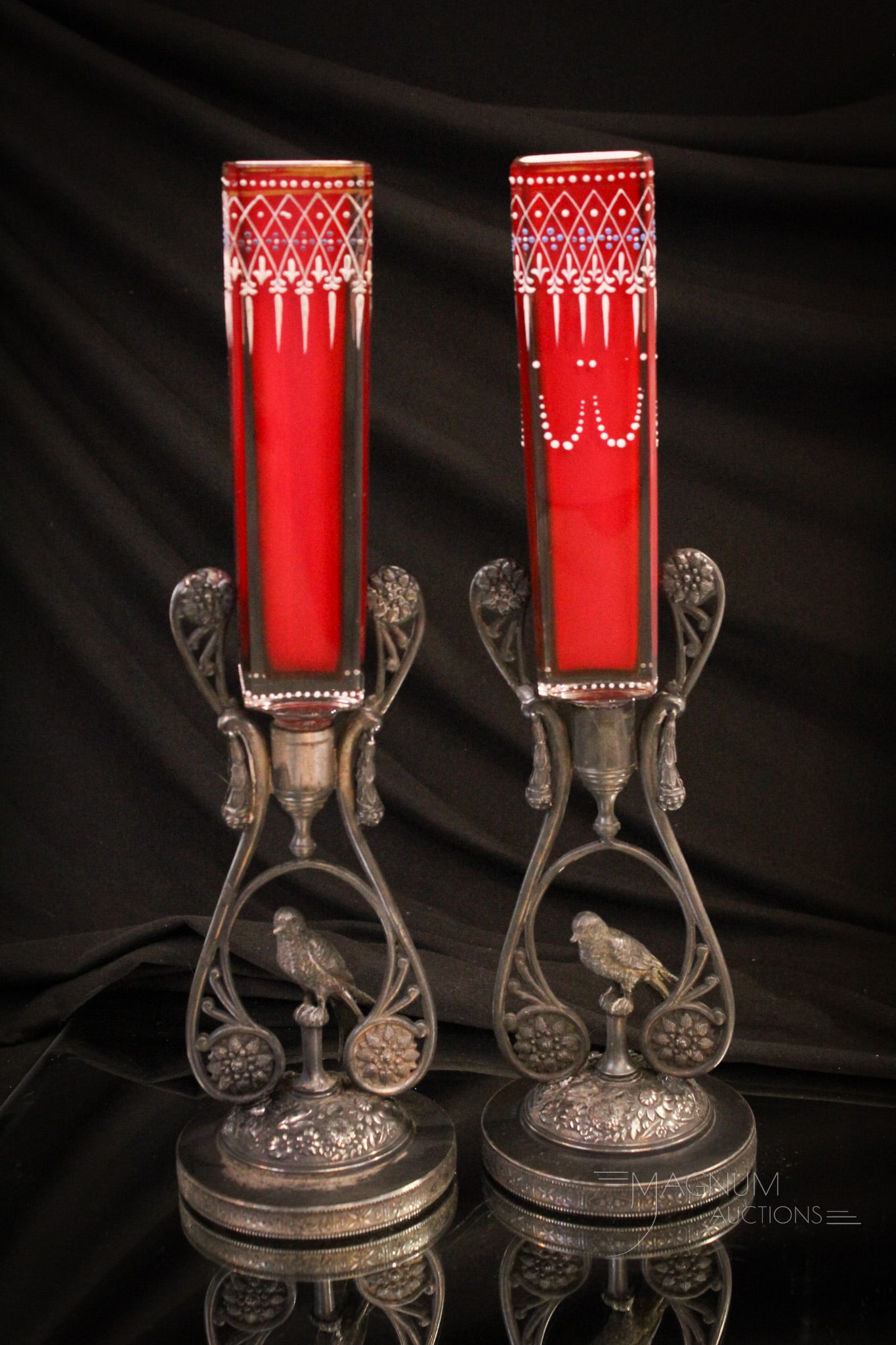 Pair Meriden Figural SilverplateCranberry Enameled Cased Glass Vases: Select offering of a pair of Victorian Meriden silverplate and cased cranberry enameled glass square form vases. Each with figural bird at the base. Glass vases are mounted in each frame. Each vase is
