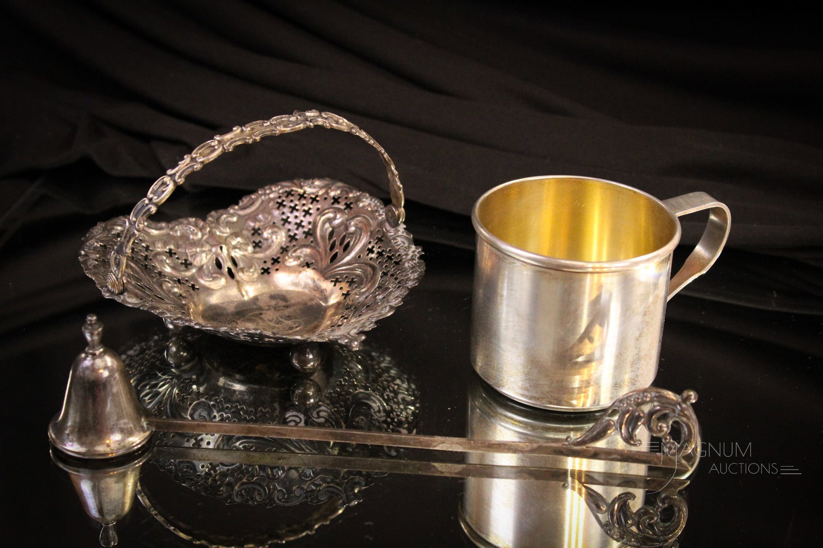 3 pc Lot Sterling Basket Childs Mug Candle Snuffer: Select offering of three fine pieces of marked sterling silver. Lot is comprised of a child's mug, a candle snuffer, and a heart shaped basket. Largest measures 7 3/4".