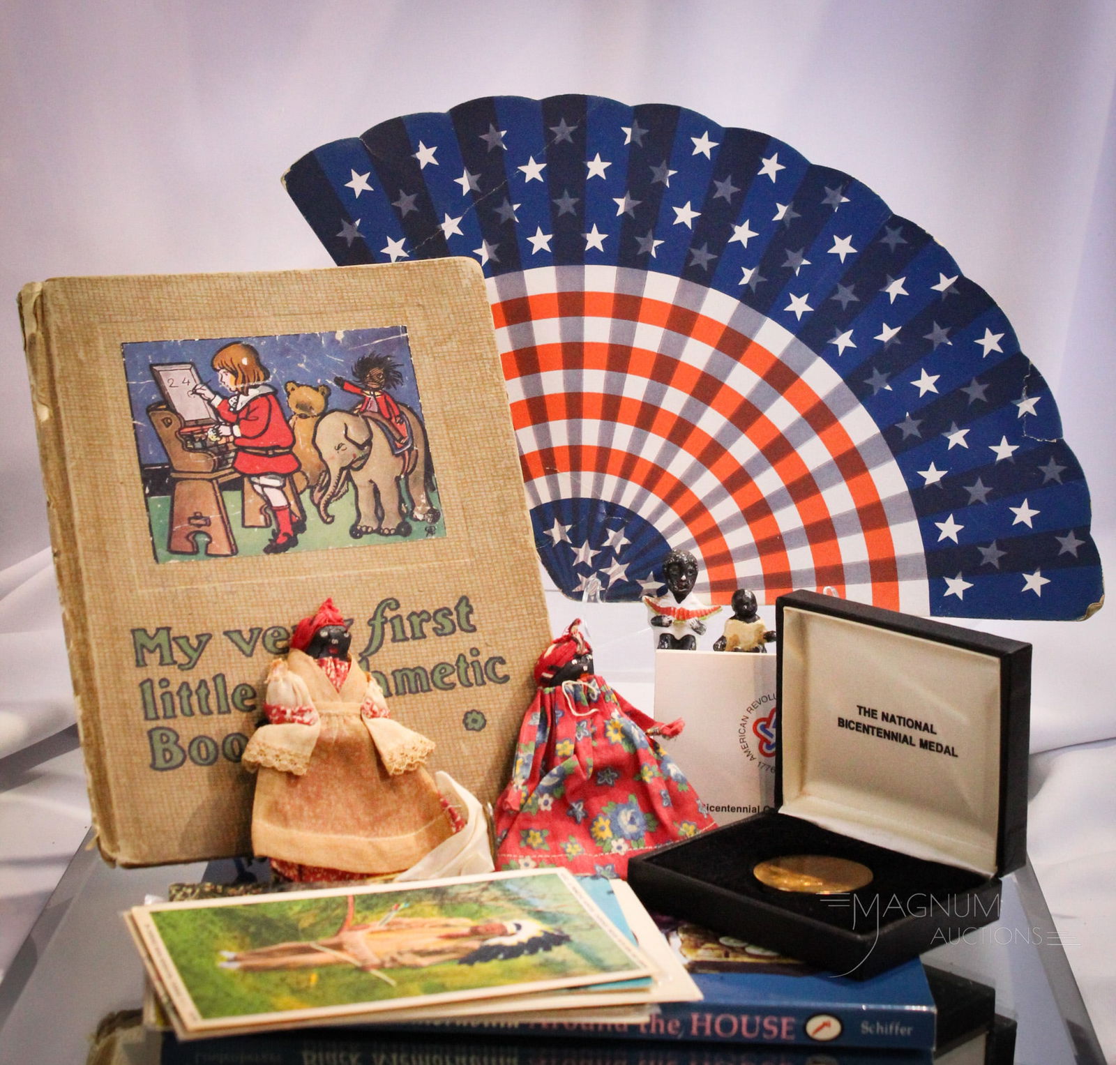 23 pc Lot Collectible Americana & Folk Art: Gracious assortment of Americana collectible items along with folk art & more. Lot is comprised of 15 postcards in various genres. A National Bicentennial medal. A reference book. Two miniature figuri