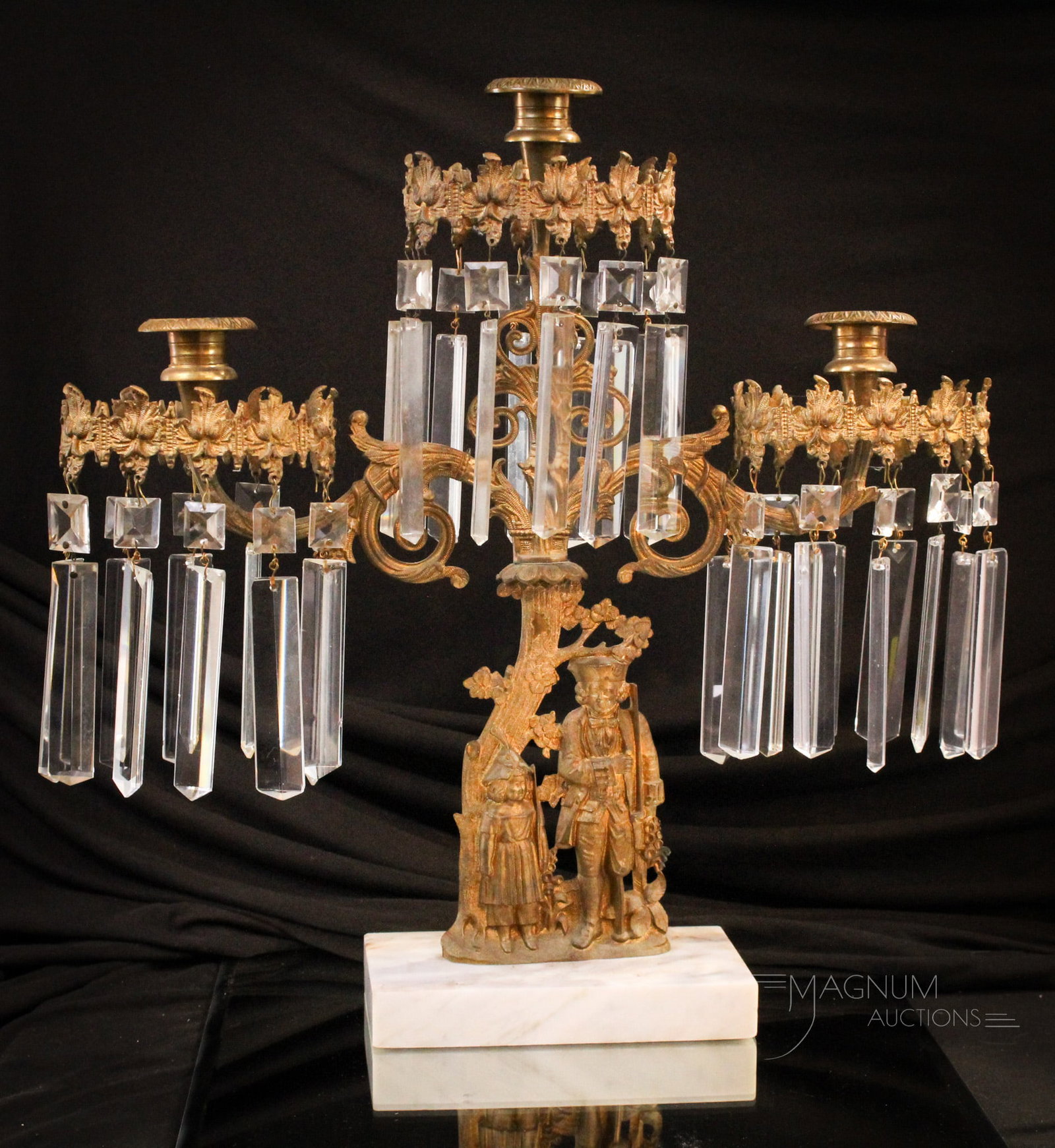 Victorian Girandole Candleabrum: Nice original Victorian girandole candleabrum complete with prisms. Featuring a man & child on the stem, this piece measures 16 3/4" tall, 16 1/2" wide.