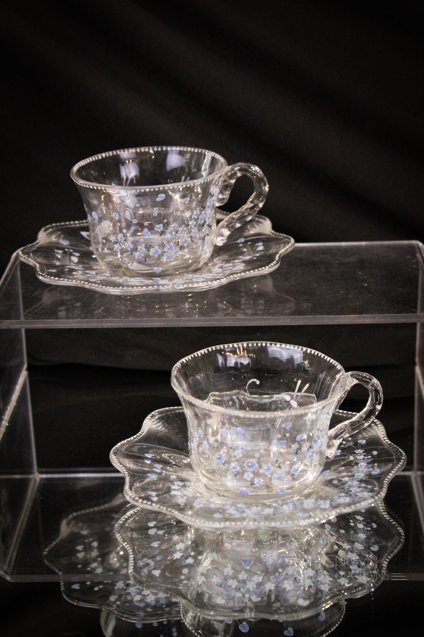 Pair of E. Galle' Art Glass Cups & Saucers: Select offering of two signed ,"E. Galle Nancy" cups and saucers with blue enameled flowers & dragonflys. Tallest measures 2".