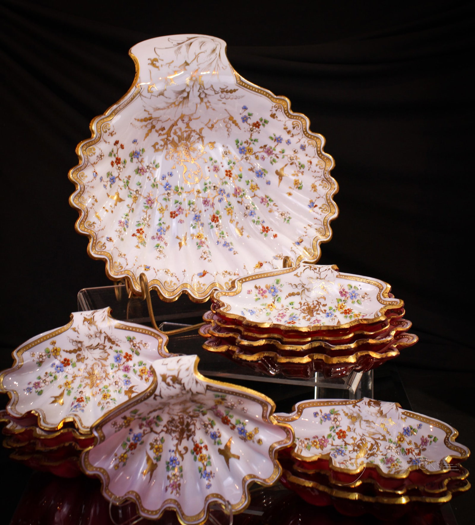 Moser Victorian Art Glass Cranberry 13 pc Enameled Gilt Scallop Shell Ice Cream Set: Absolutely fantastic Victorian cased cranberry glass thirteen piece ice cream set. Set features large master bowl with a complete set of individual bowls. Each is ornately enamel and gilt decorated on