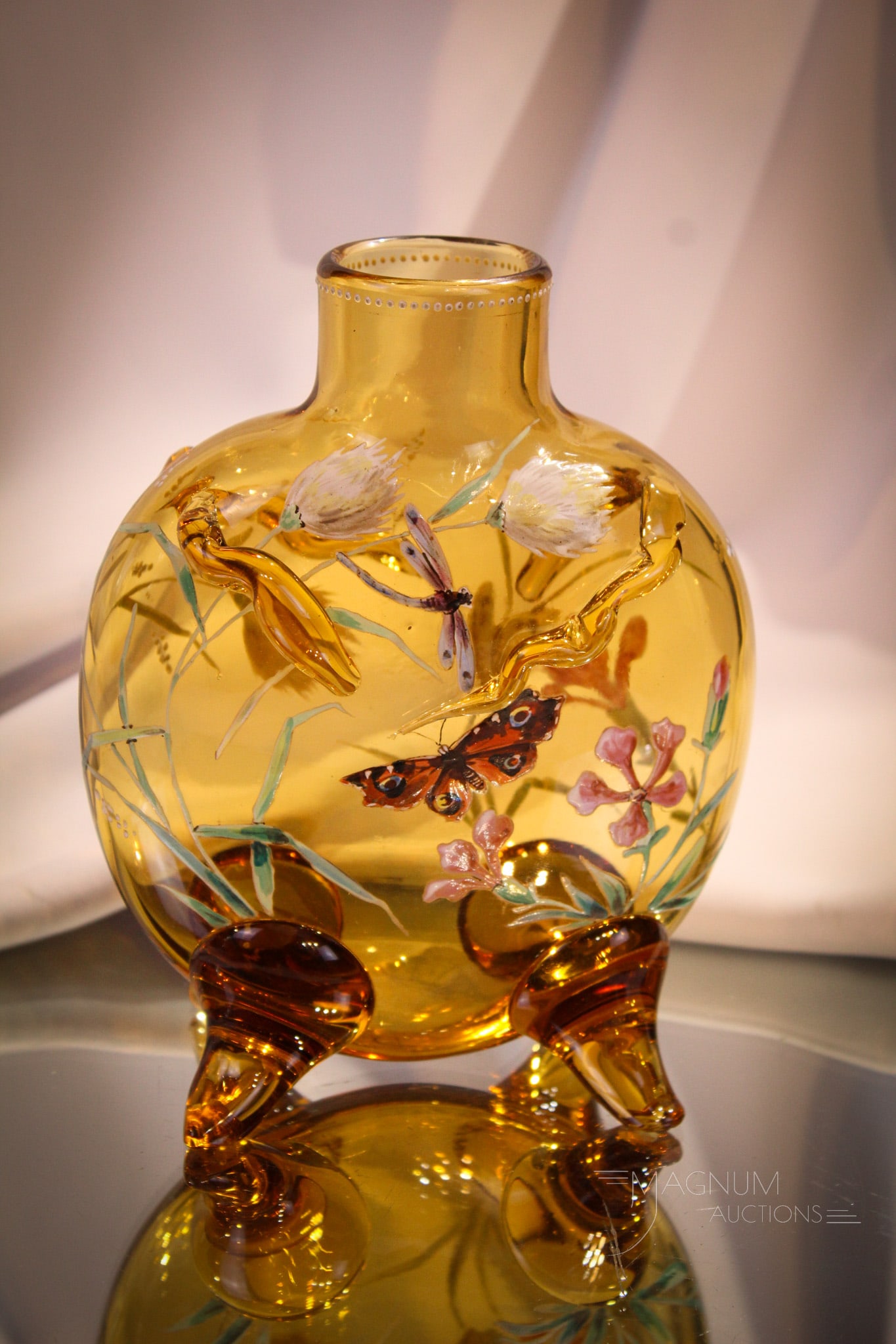 Victorian Honey Amber Enameled Pillow Vase Butterflies & Dragonflys: Beautiful honey amber gilt and enameled applied glass pillow vase. Piece is adorned with enameled butterflies, flowers, and dragonflys. Measures 6 3/4".