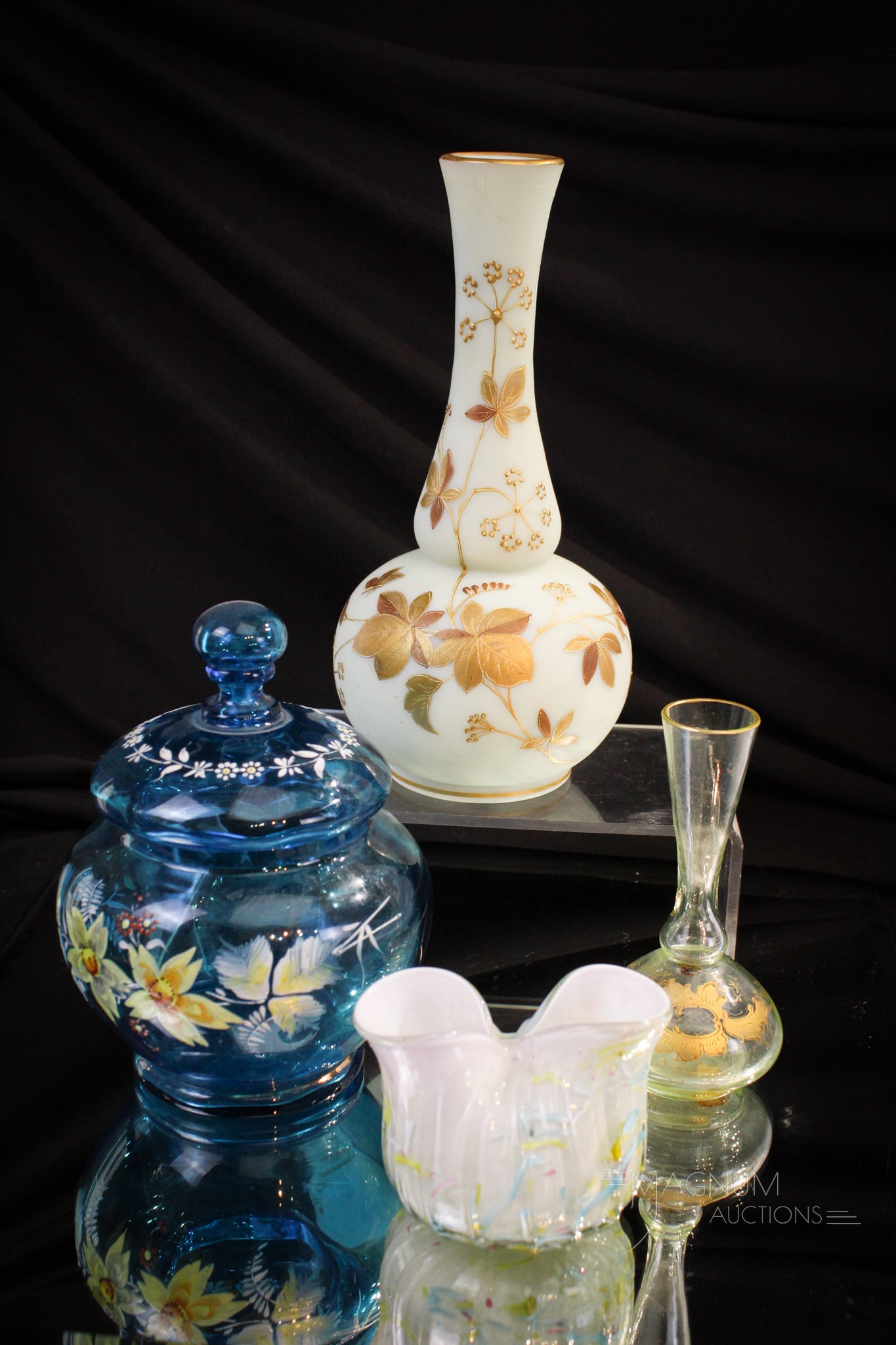 4 pc Lot Victorian Harrach Peloton & More Glass: Select offering of Victorian art glass. Examples by Harrach and more. Included is a gilt and enameled vase along with a pinched top peloton pouch vase. Tallest measures 8 1/2" tall.