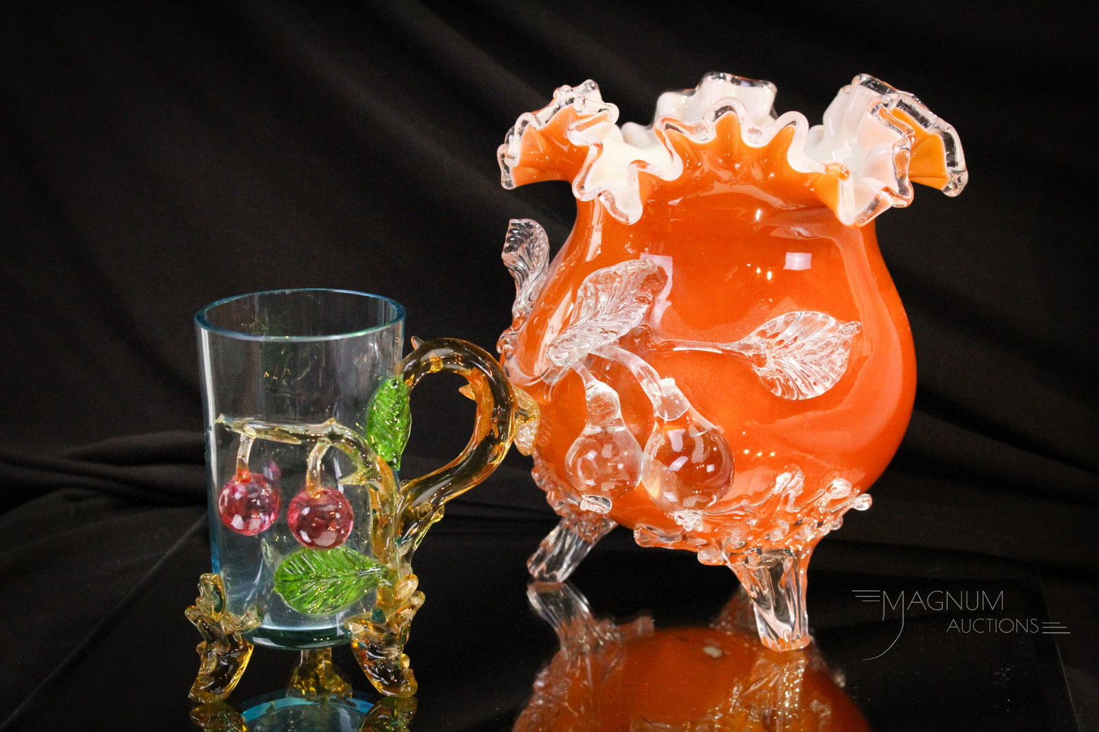 2 pc Lot Stevens & Williams Applied Glass Vase & Cup: Two fine examples of the applied glass of the Victorian Era. A large orange colored vase with applied pears and foliage. This along with an applied cherries and foliage cup. Tallest measures 7 1/4".
