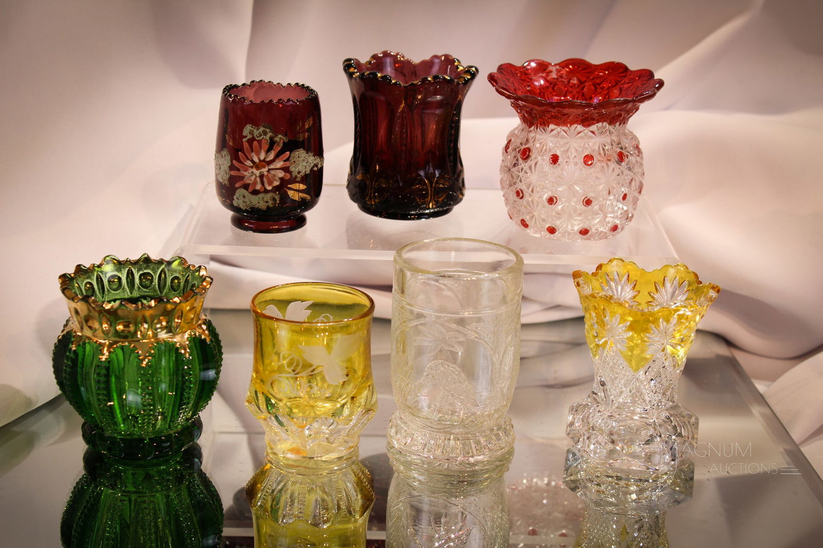 7 pc Lot Victorian EAPG Victorian Glass Toothpick Holders: Seven select examples of Victorian pattern glass toothpick holders. Amber & ruby stained, amythest, green, and clear. Tallest measures 3".