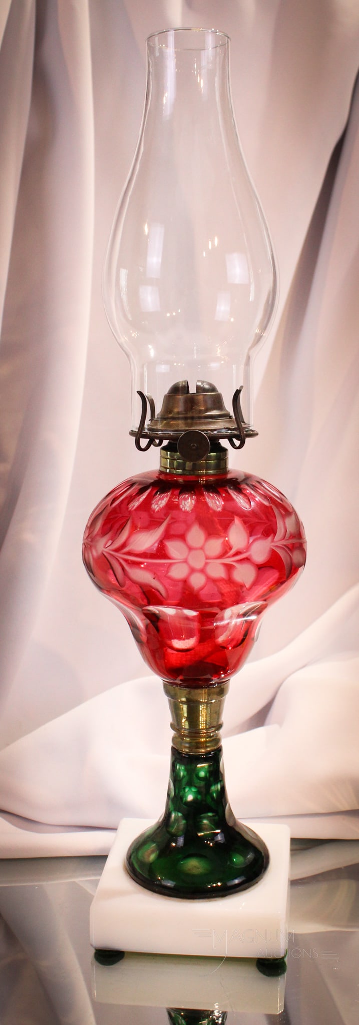 Antique Victorian Cranberry Emerald Green Cut Overlay Oil Lamp: Nice find in this cranberry cut overlay oil font lamp complete with unusual emerald green cut overlay stem and milk glass base. Lamp measures 9 3/4" tall for the glass portion only.
