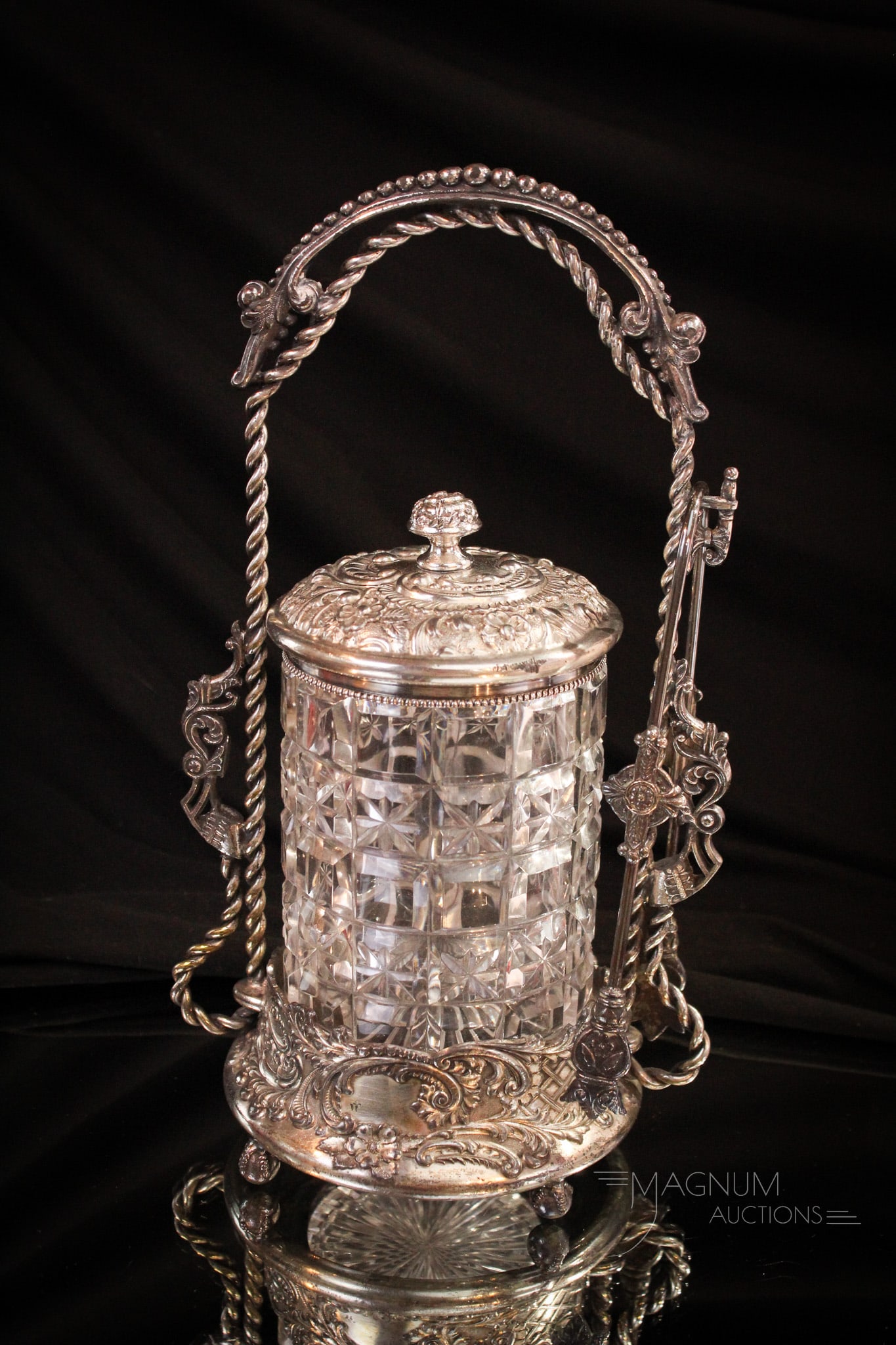 Wilcox Ornate Silverplate Victorian Glass Pickle castor: A fine find in this signed ornate Wilcox silverplate Victorian pickle castor frame. Frame houses a clear block and star insert original to the frame. It stands erect at 10" tall.