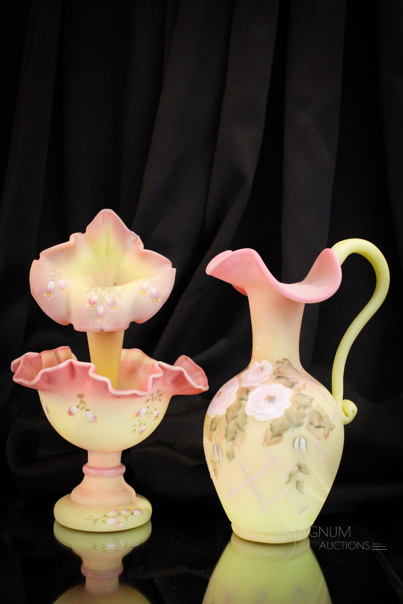 2 pc Lot Fenton Burmese Hand Painted Art Glass: Great offering of two fine pieces of Fenton art glass in burmese. This pairing is comprised of an epergne and a limited edition ewer numbered 610/750. Tallest measures 10 1/2".