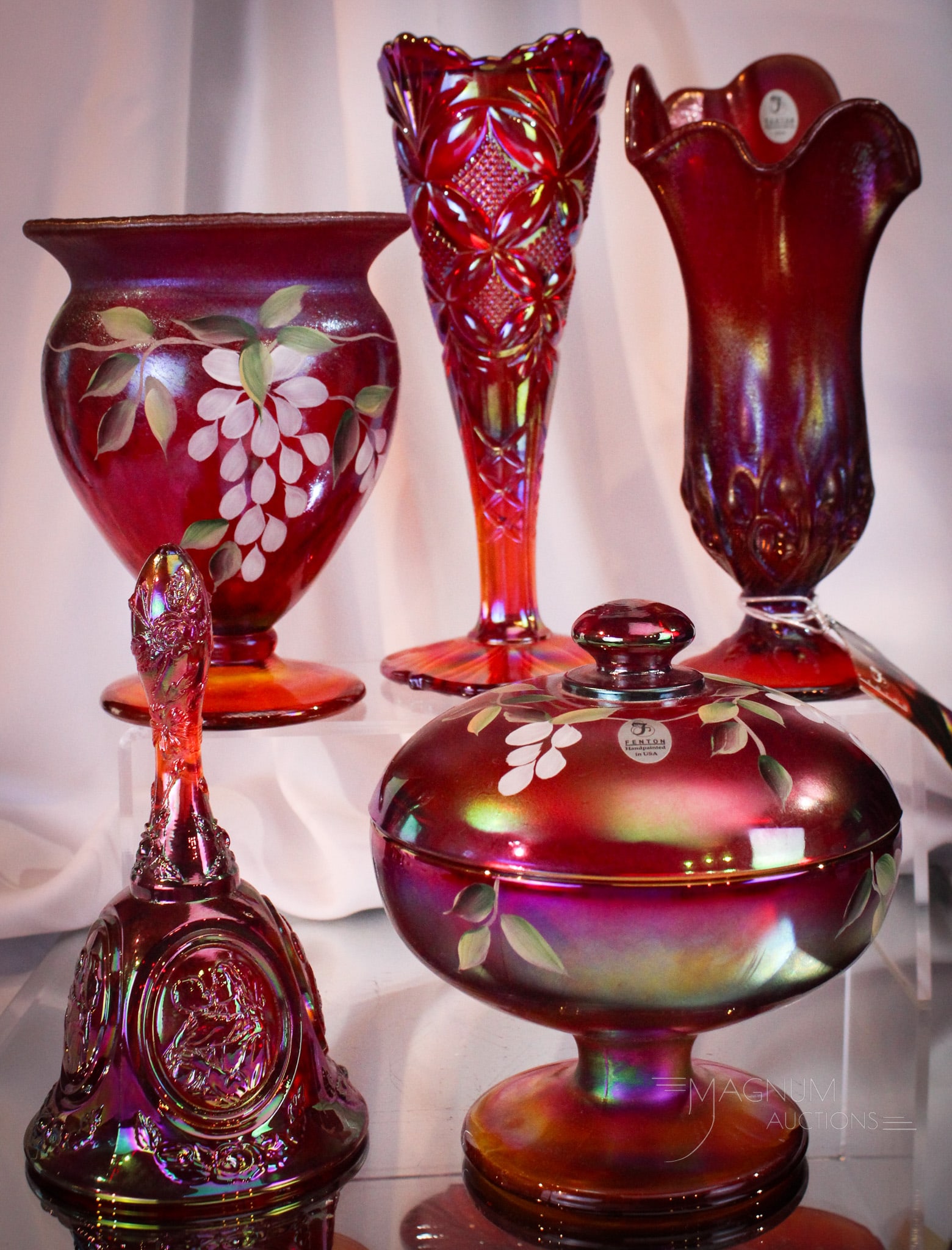 5 pc Lot Red Fenton Carnival Glass: Five fine pieces of Fenton red carnival glass. Lot is comprised of two pieces that are hand painted. That being a vase and covered candy. The remainder undecorated in the form of two vases and a bell.