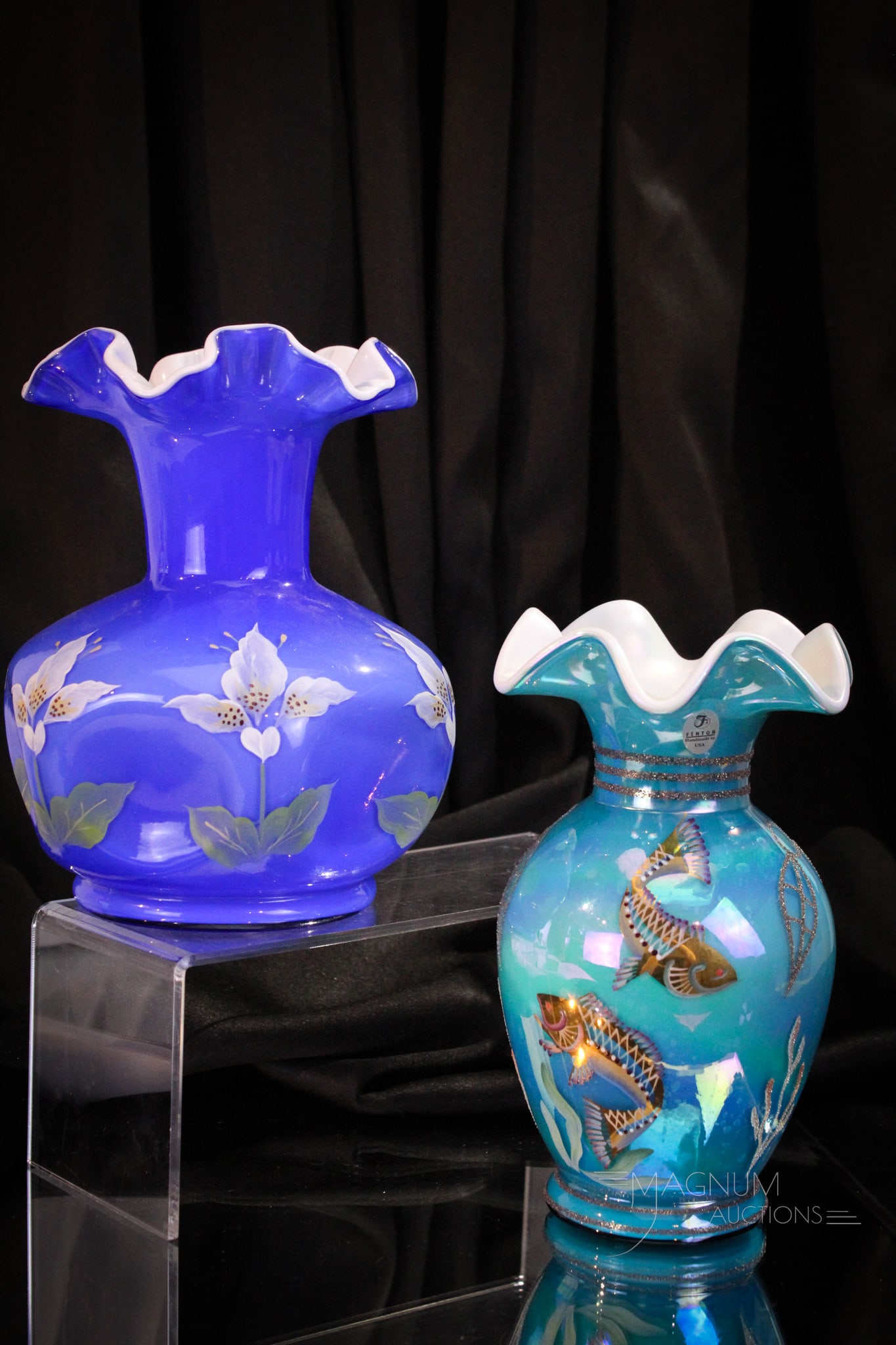 2 pc Lot Fenton Art Glass: Two piece lot of Fenton art glass comprised by a blue cased hand painted pinch vase along with a turquoise "Under the Sea" cased vase. Tallest measures 8 1/2".