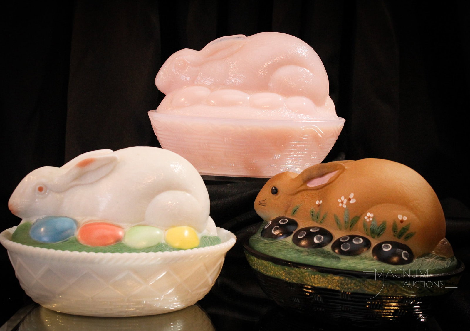 3 pc Lot Fenton & Westmoreland: Three fine examples of Fenton and Westmoreland glass rabbit and egg covered dishes.Fenton example with hand painting and black base. Another Fenton example in pink milk glass. Trio is completed by a h