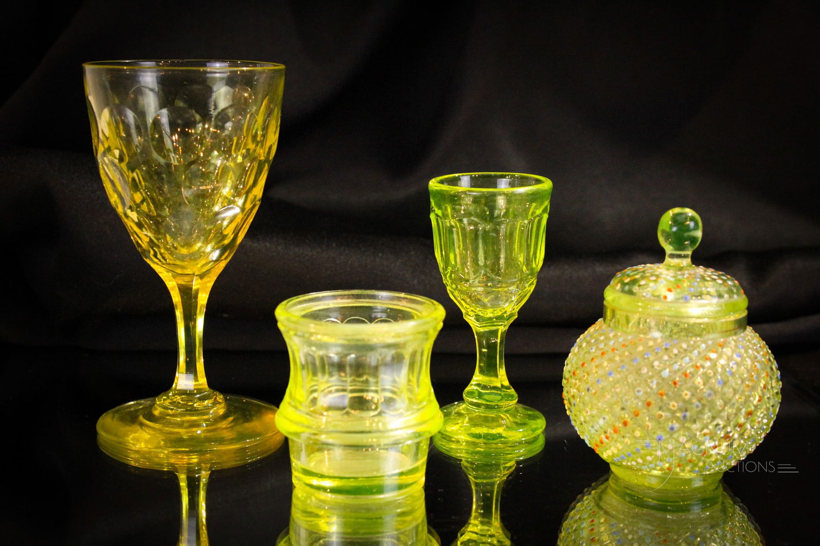 4 pc Lot Victorian Vaseline Glass Flint & More: Select offering of four pieces of Victorian vaseline flint and more glass. Included in the lot is a flint wine, an English cordial, an inkwell base or toothpick holder, and completed by a covered jar