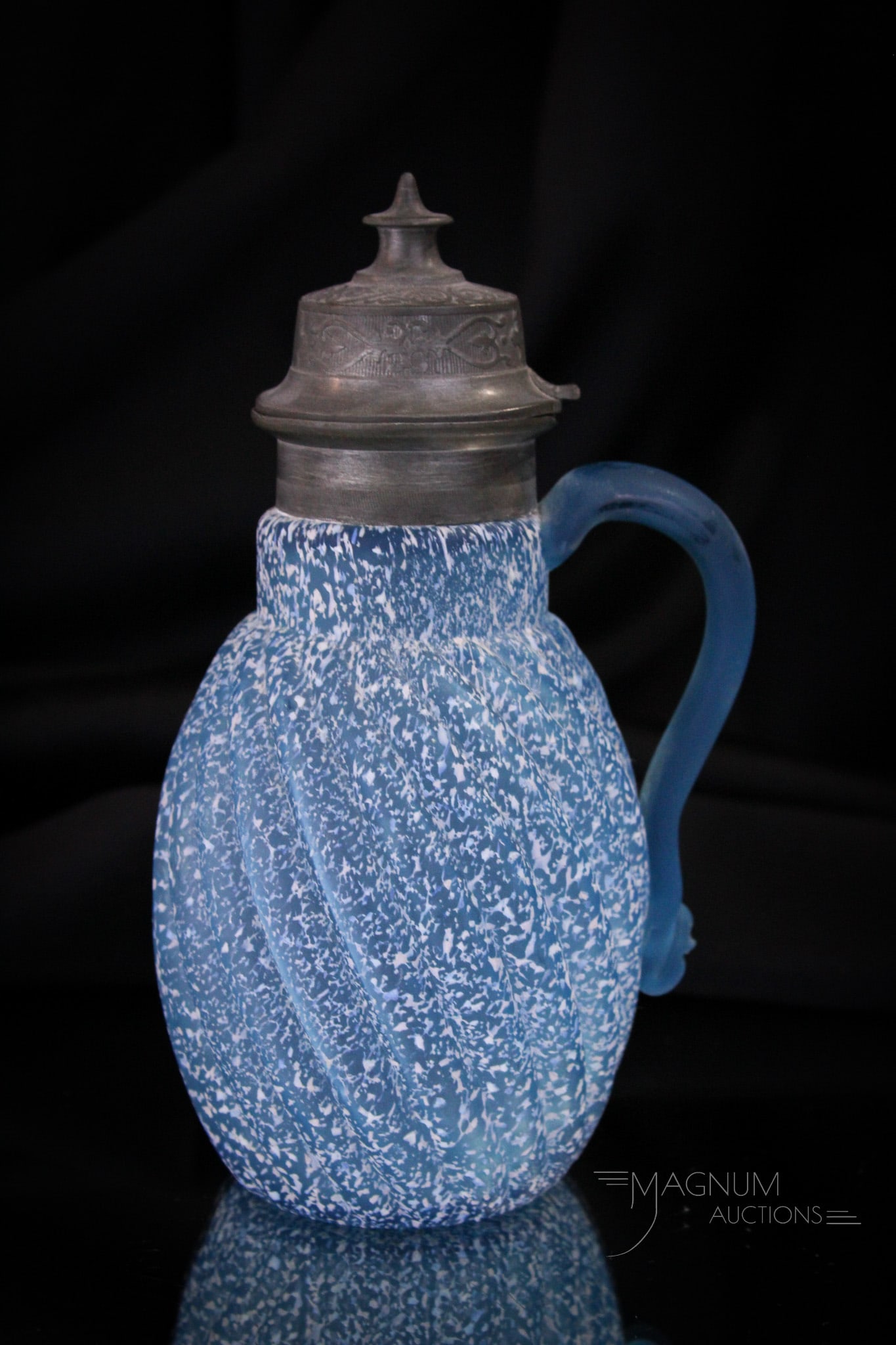 Victorian Reverse Swirl Granite Glass Syrup Pitcher: Vivid blue color makes this Victorian syrup a stand-out piece for your collection. This one in the Reverse Swirl pattern. It stands 7 1/4" tall.