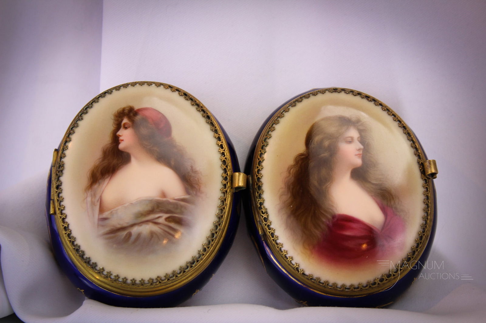 Pair of Roayl Vienna Style Portrait Trinket Boxes with Silk Lining: Select offering of two fine Royal Vienna style portrait trinket boxes. Each with original silk lining in the lids. Each bearing double fork mark on the base. Each box measures 1 1/2" tall, 3" wide, an