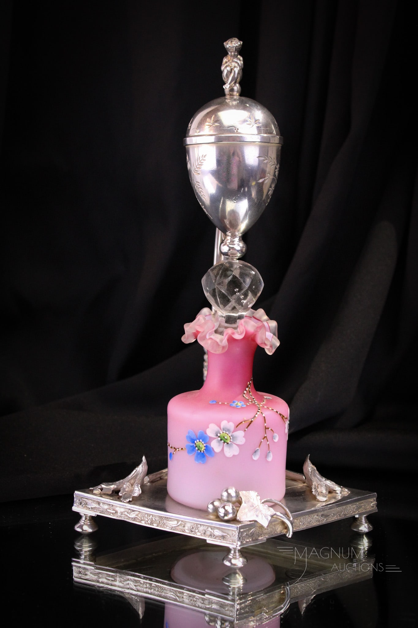 Rogers Silverplate Victorian Perfume Castor Jewel Casket: Wonderful pink satin enameled Victorian perfume bottle residing in signed Wilcox silverplate castor frame. Frame features jewelry casket at the top with a wee little cherub perched on the lid. Complet