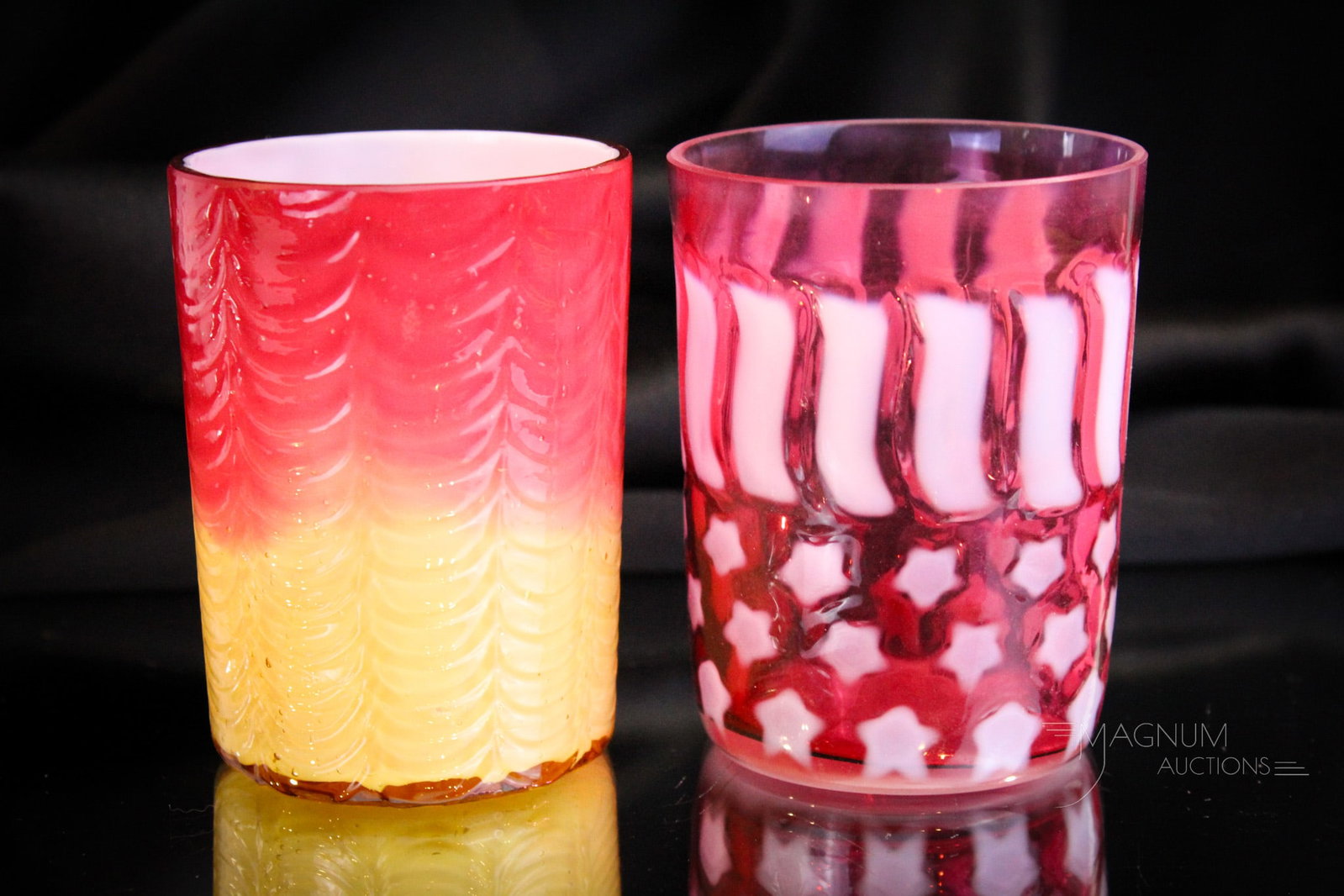 2 pc Lot Victorian & More Glass Tumblers Phoenix & L.G. Wright: Two fine art glass tumblers. A peachblow cased Phoenix Drape pattern along with a Fenton for L.G. Wright cranberry opalescent Strars & Stripes example. Tallest measures 3 3/4".