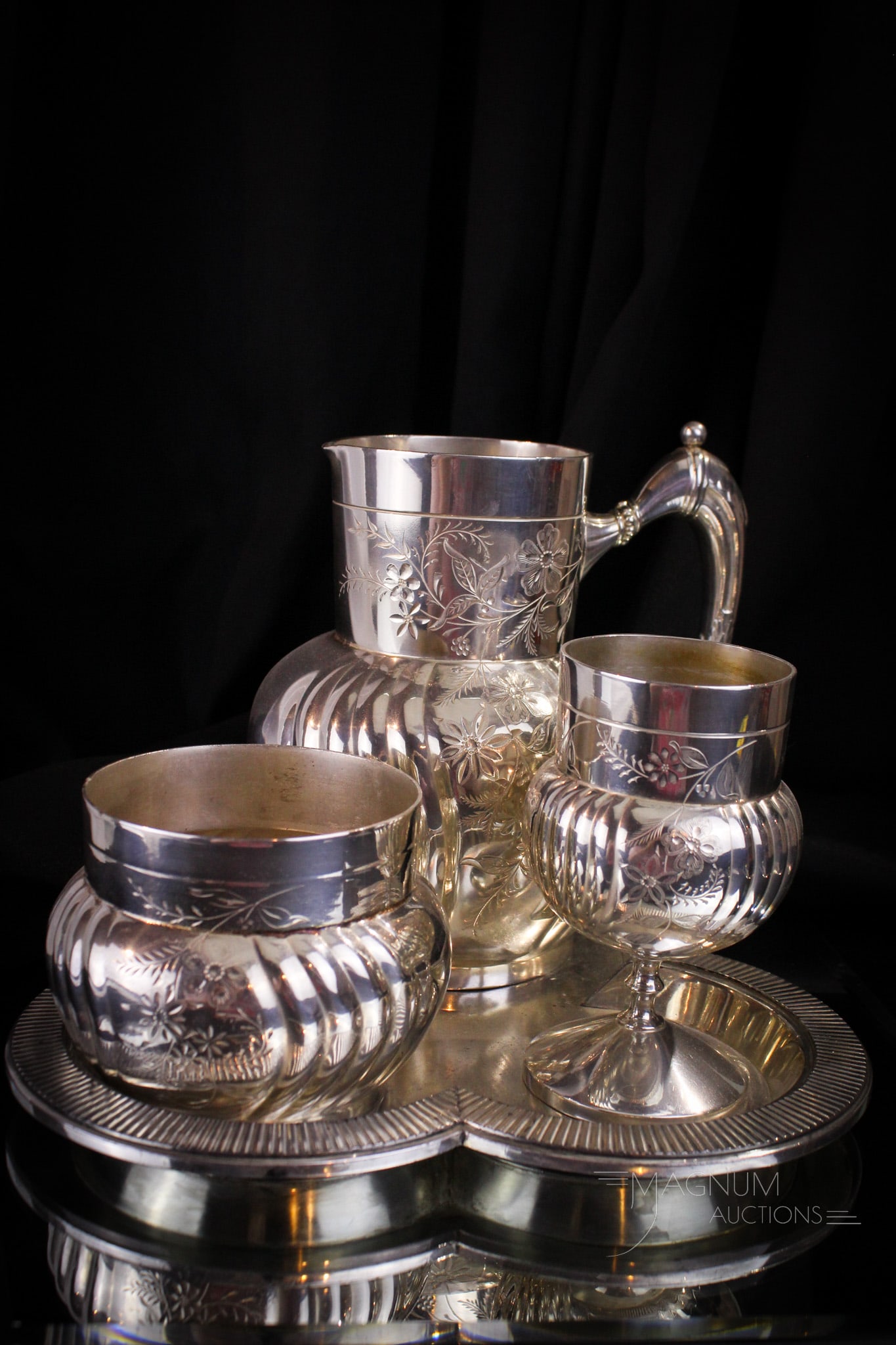 Webster Victorian Silverplate Lemoade Set: Select offering of a Victorian signed Wilcox silverplate lemoade set on tray. This fine example is beautifully ornate and lovely enough for any dining room. Measures 7 3/4" tall, 12" wide.