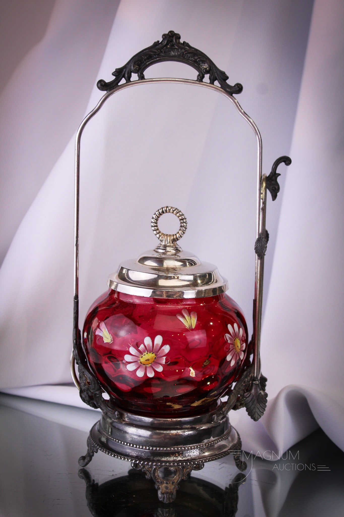 Homan Cranberry Enameled Silverplate Victorian Pickle Castor: Such a delight to behold. This fine castor is complete with cranberry enameled glass insert and frame is signed Homan silverplate. Complete it measures 11 1/2" tall.
