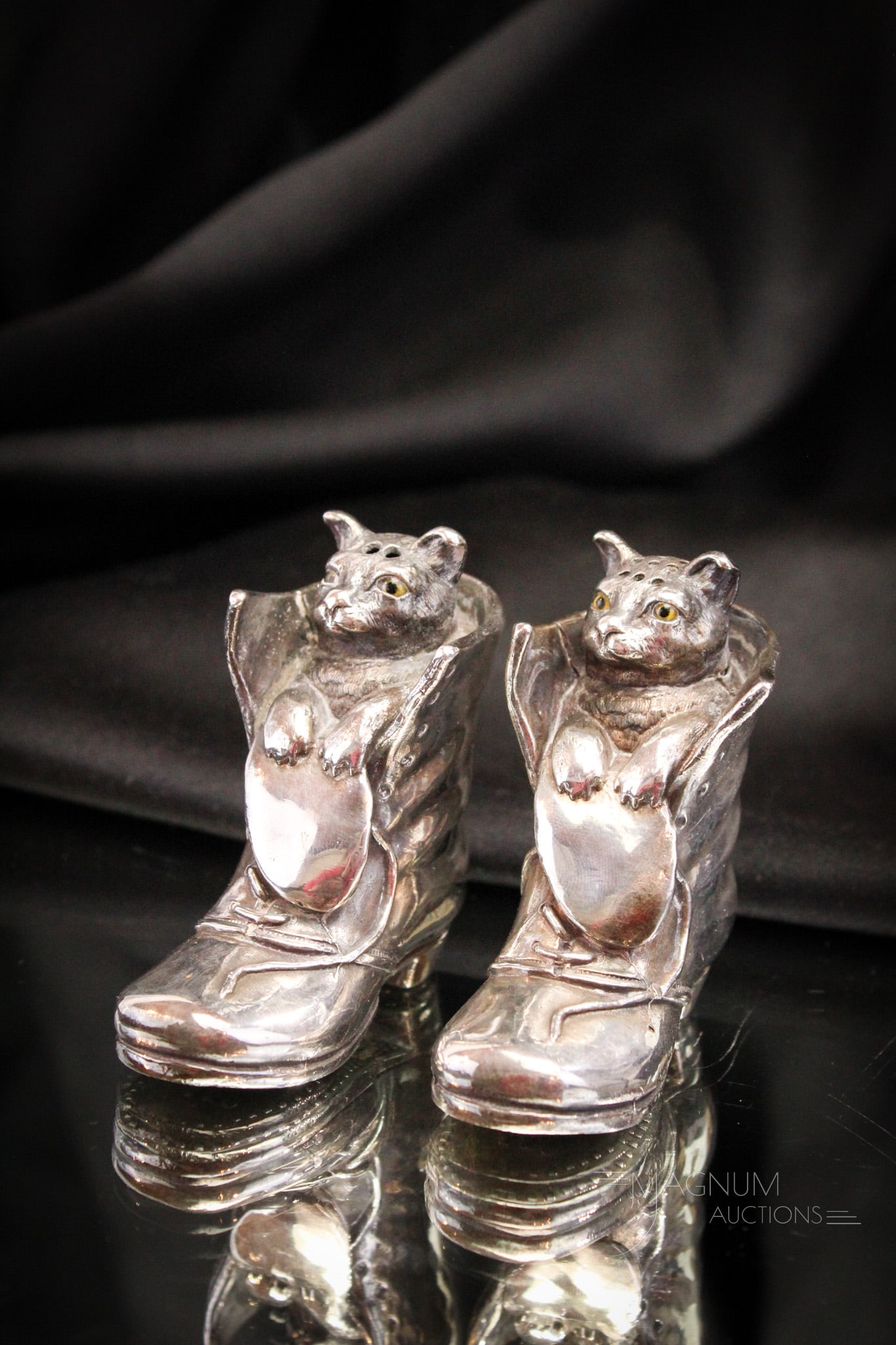Rare Figural Silverplate Puss in Boots Cat Salt Shaker Pair: Fine select offering of two rare Victorian figural silverplate salt shakers. Each is in the form of a puss in boot. Each shaker features glass eyes. Both measure 3" tall.