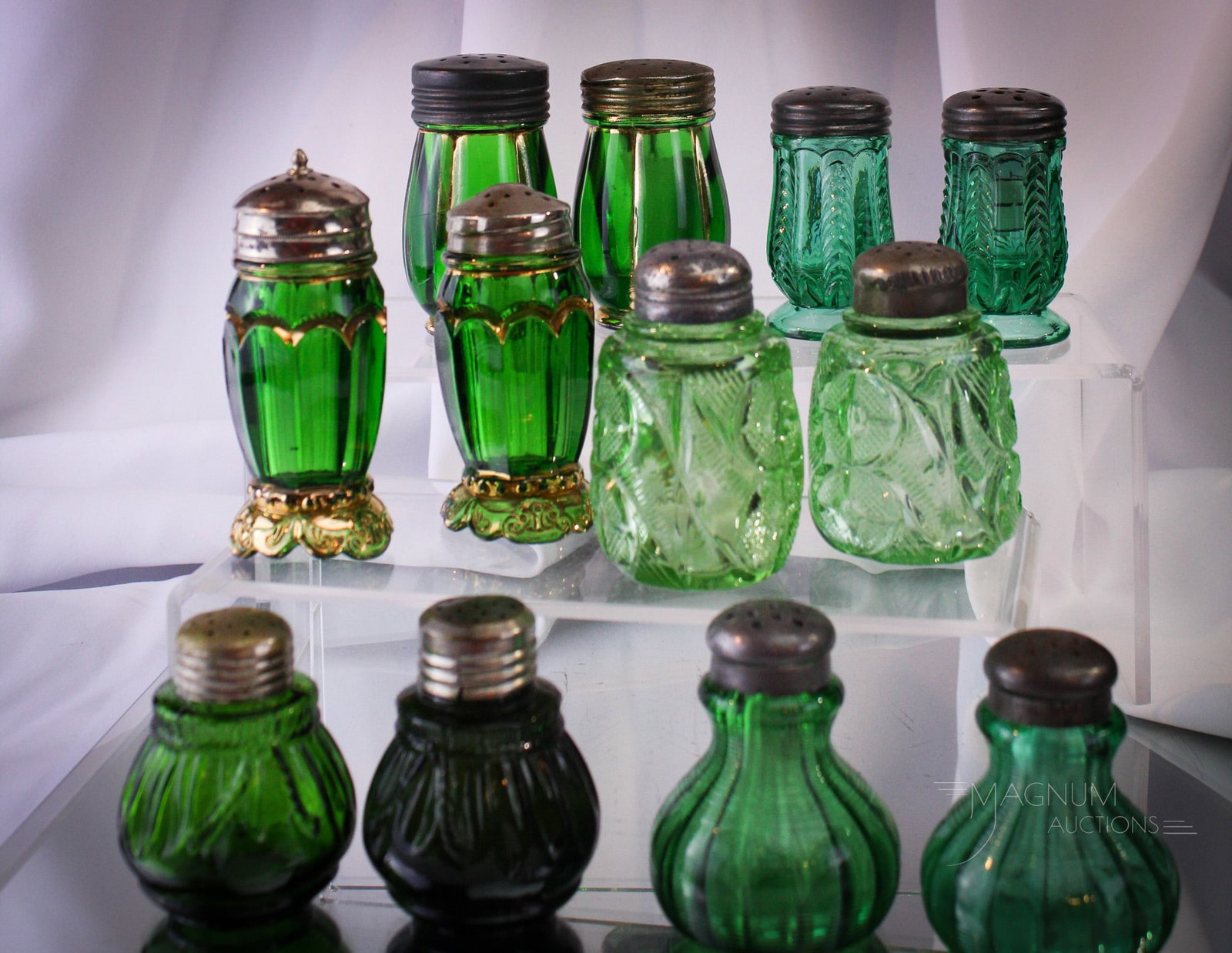 12 pc Lot Victorian Green Glass Riverside & More Salt Shakers: Twelve fine examples of Victorian salt shakers. Some are Riverside glass. Can you spot them? All shakers are in pairs. Tallest measures 4".