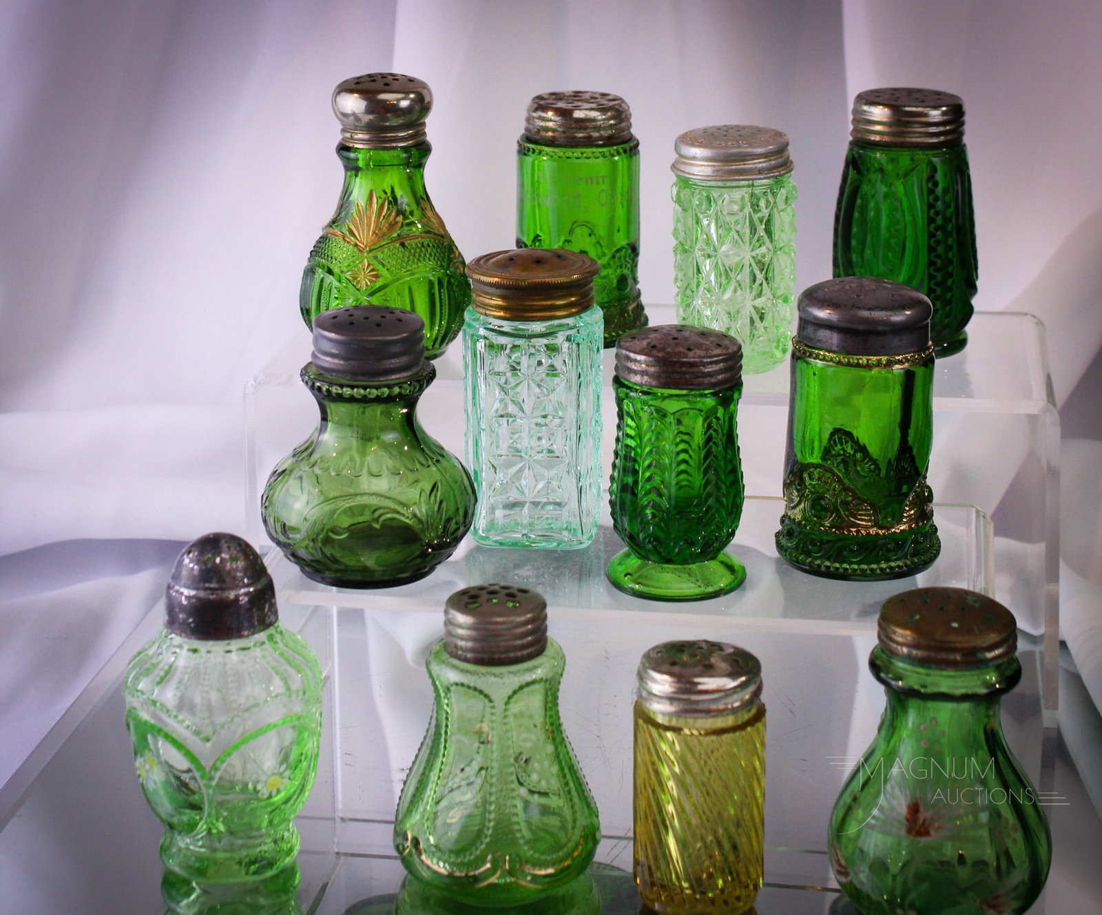 12 pc Lot Victorian Glass Salt Shakers: So many glorious shakers to bid on! This wonderful assortment is just right for the Salty in your life. Eleven green with envy e3xamples and one amber just for fun. Tallest measures 3 1/4" high.