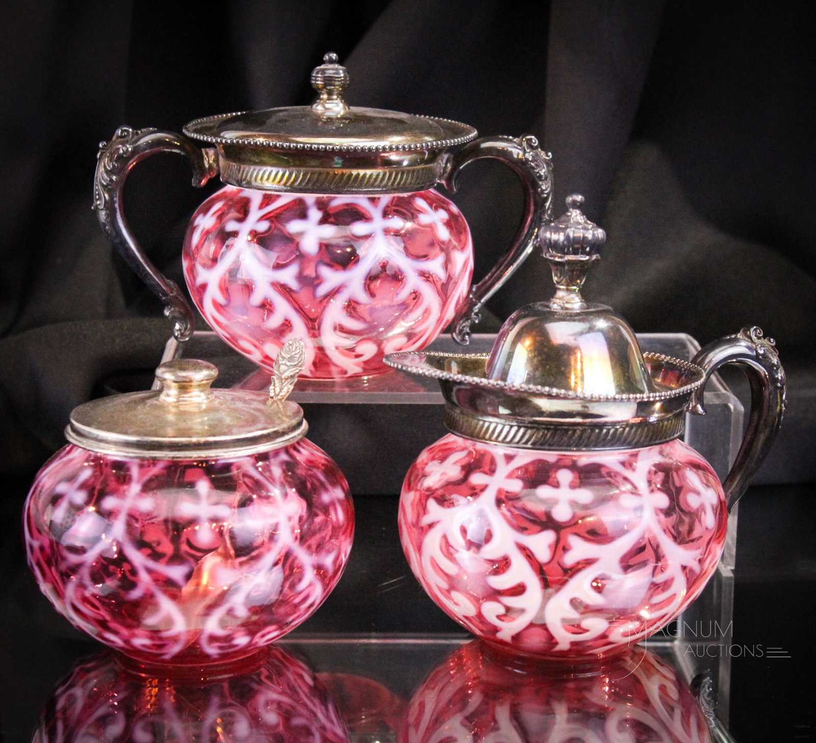 3 pc Set Cranberry Opalescent Spanish Lace Victorian Northwood Glass: Three beautiful pieces in Northwood cranberry opalescent glass featuring silverplate mountings. In the set is a cream and sugar along with a jam jar complete with spoon.