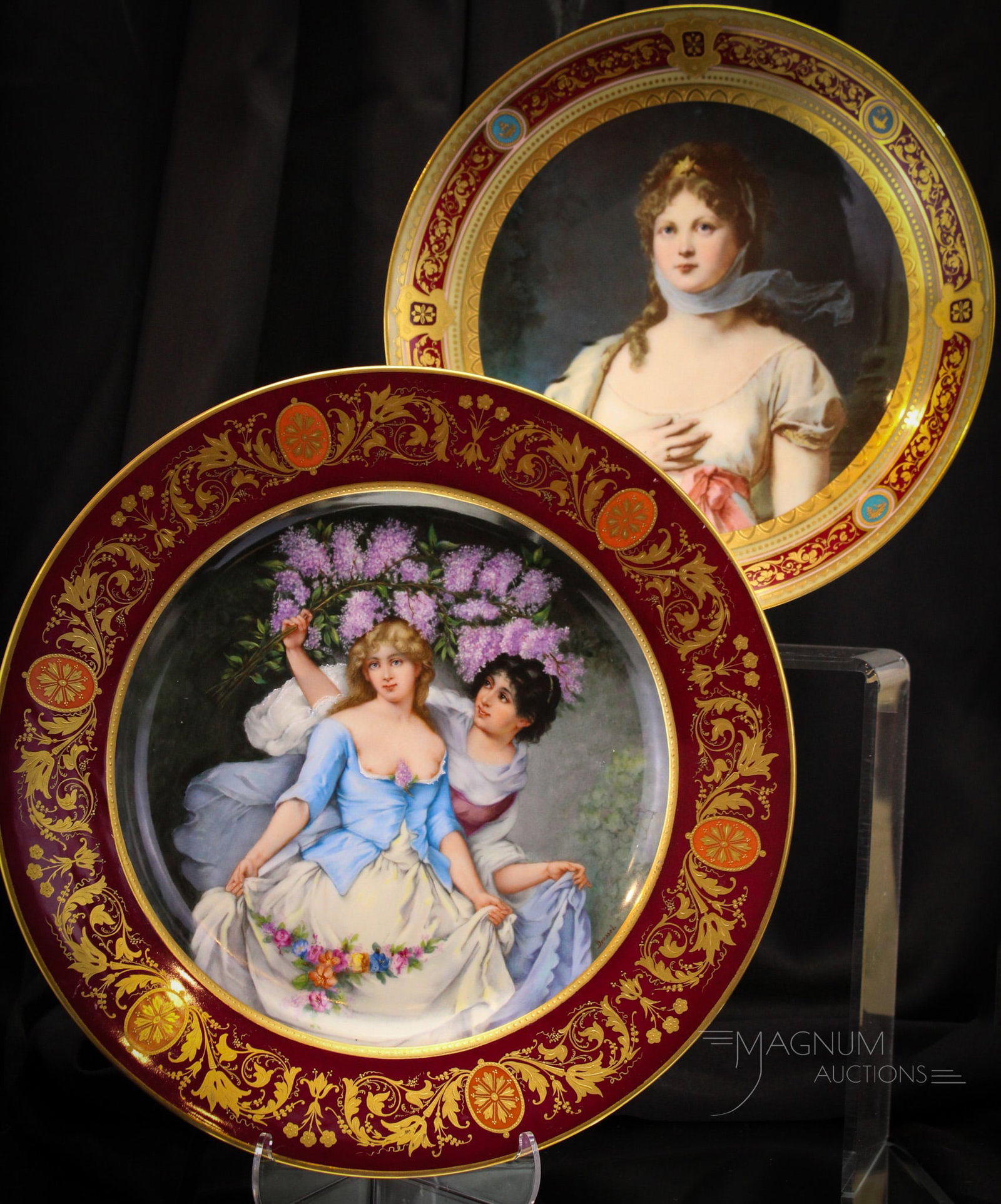 2 pc Lot 13" Royal Vienna Porcelain Portrait Plates "Konigen Luise" & Frolicking Lilacs": Two fine examples of Hand Painted Royal Vienna Porcelain chargers. Each expertly decorated. Both with an abundance of gold. The first a "Konigen Luise" example. The secon with a pair of ladies frolick