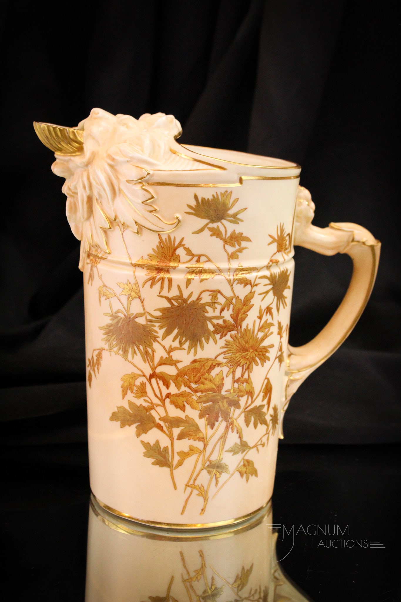 Royal Worcester Lion Motif Porcelain Water Pitcher: Fine Royal Worcester porcelain lion motif adorned water pitcher with gilt trim and florals. The Pitcher measures 8 1/2" tall.