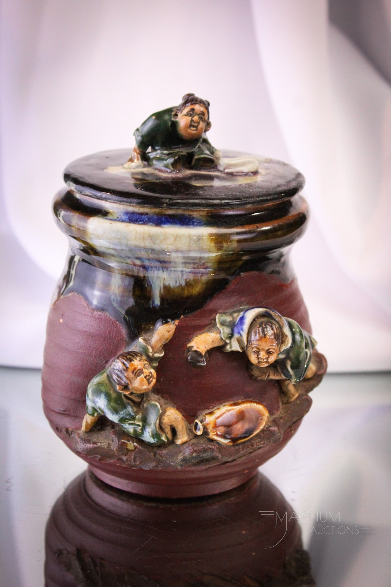 Sumida Gawa Pottery Humidor: Fine Sumida Gawa pottery humidor featuring two men on one side and one on the lid. Piece measures 6" tall.