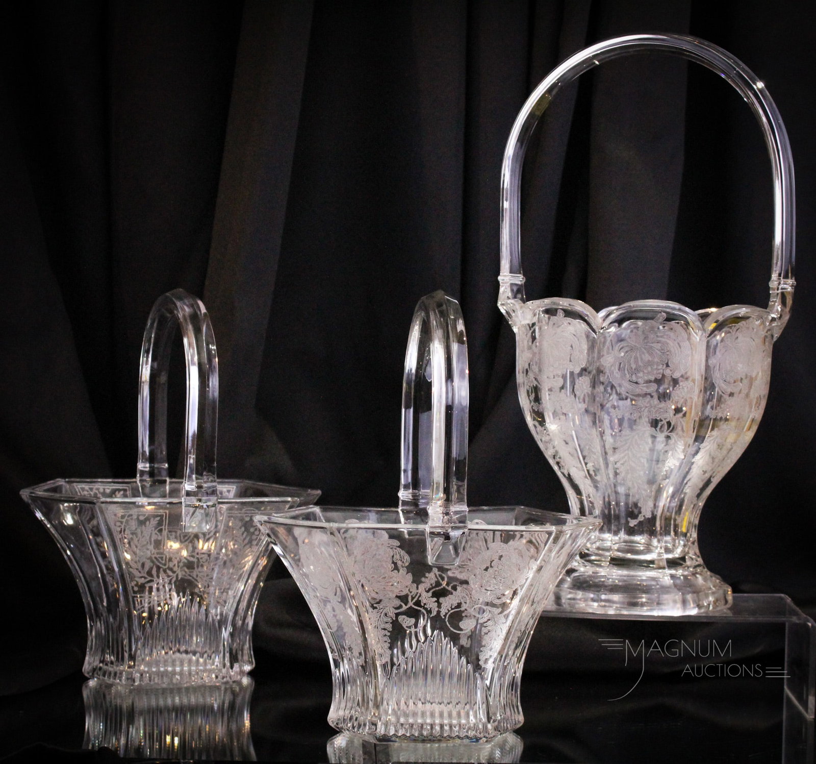 3 pc Lot Etched Heisey Glass Baskets: Three select examples of wonderful clear etched Heisey glass baskets. The tallest measures 15". Perfect for the size queen.