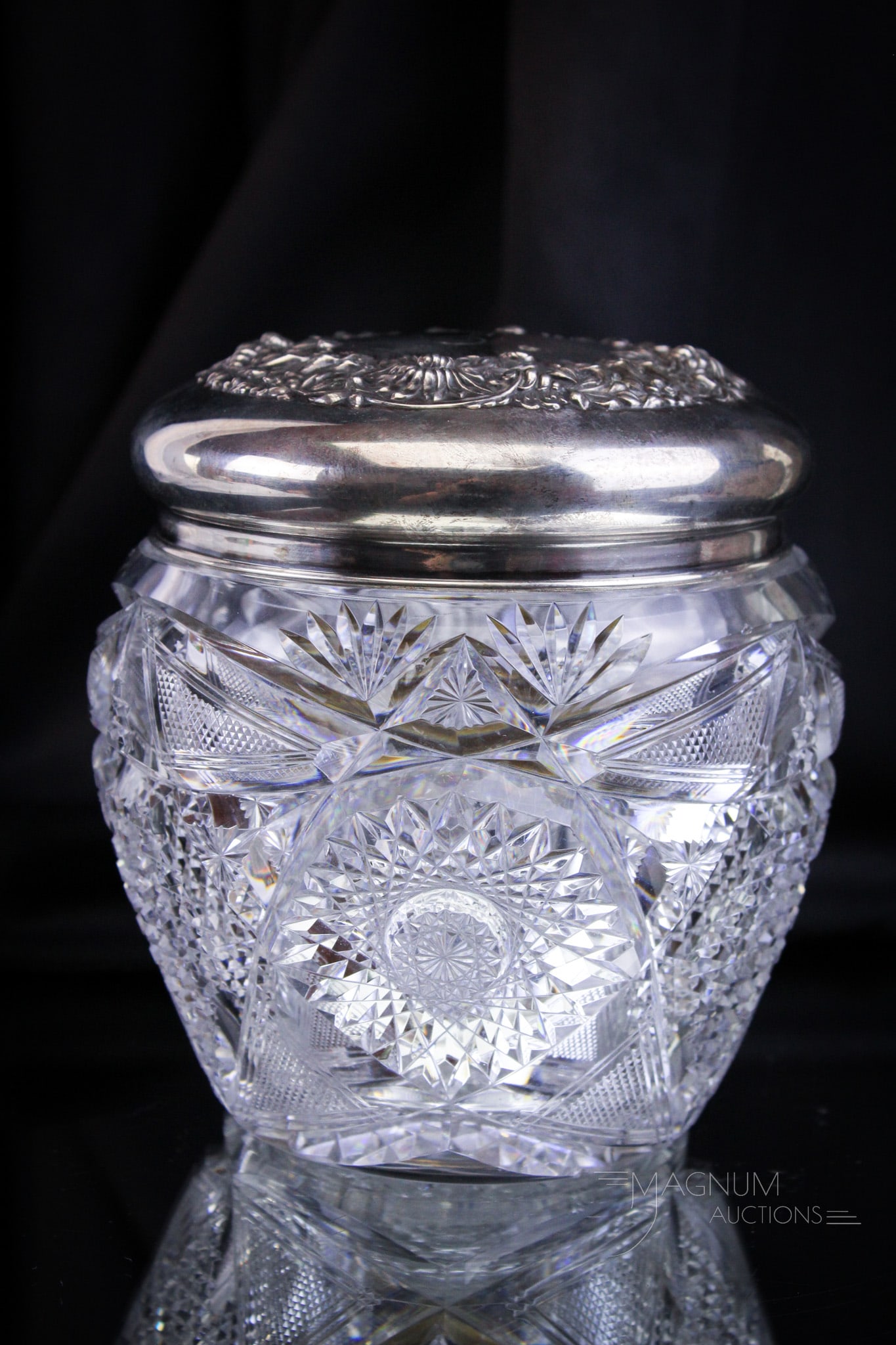 ABP American Brilliant Period Cut Glass Sterling Humidor Hobstar & Diamond: Select find in this sterling lidded humidor in the cut pattern Hobstar and Diamond. Lid is embossed with florals. Piece measures 6 1/4" tall.