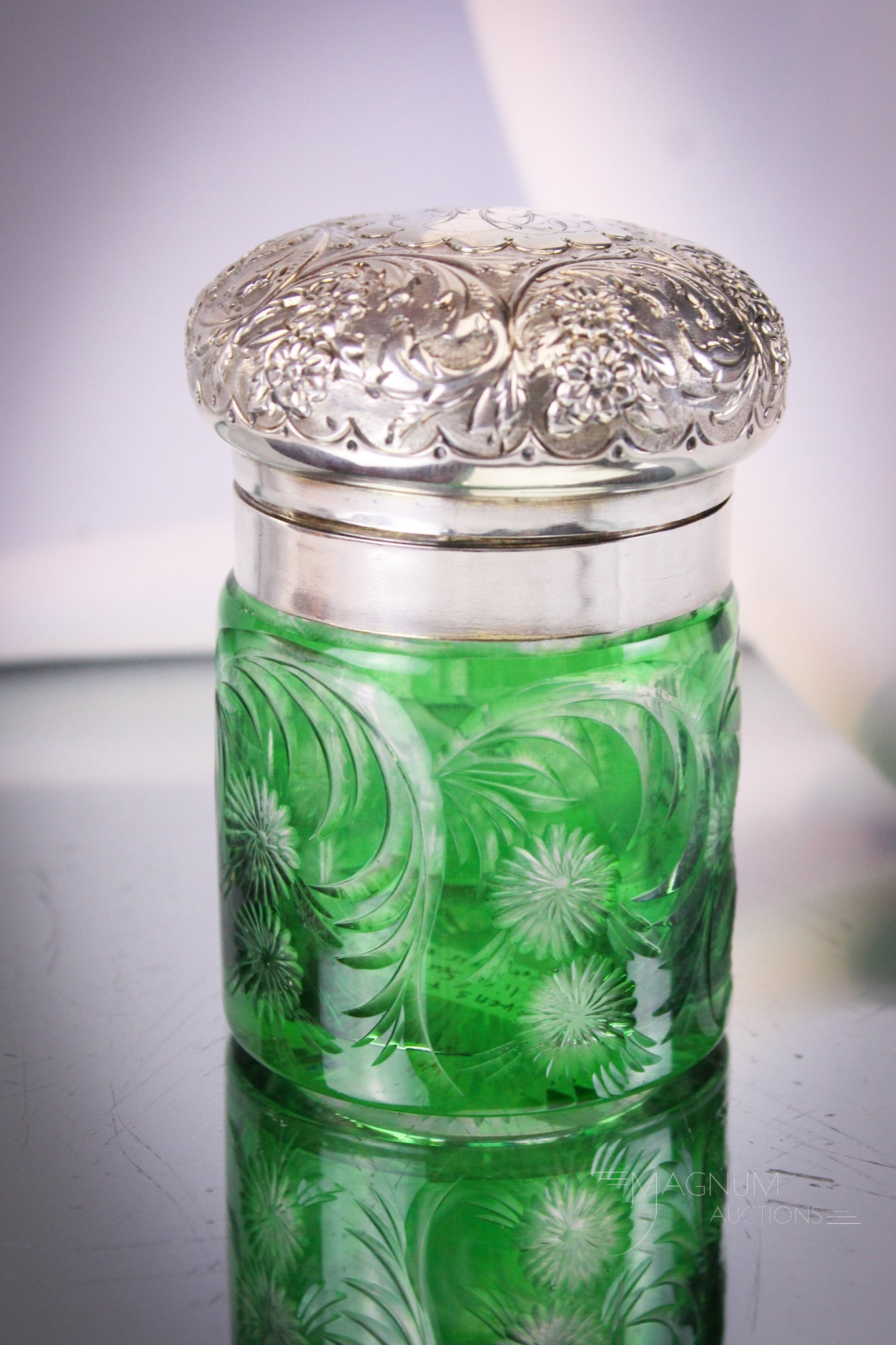 Stevens & Williams Green Cut to Clear Glass & Sterling Smelling Salts Jar: So pretty green cut to clear Stevens and Williams smelling salts jar complete with stopper and sterling repousse lid. Piece measures 3 1/2" tall.