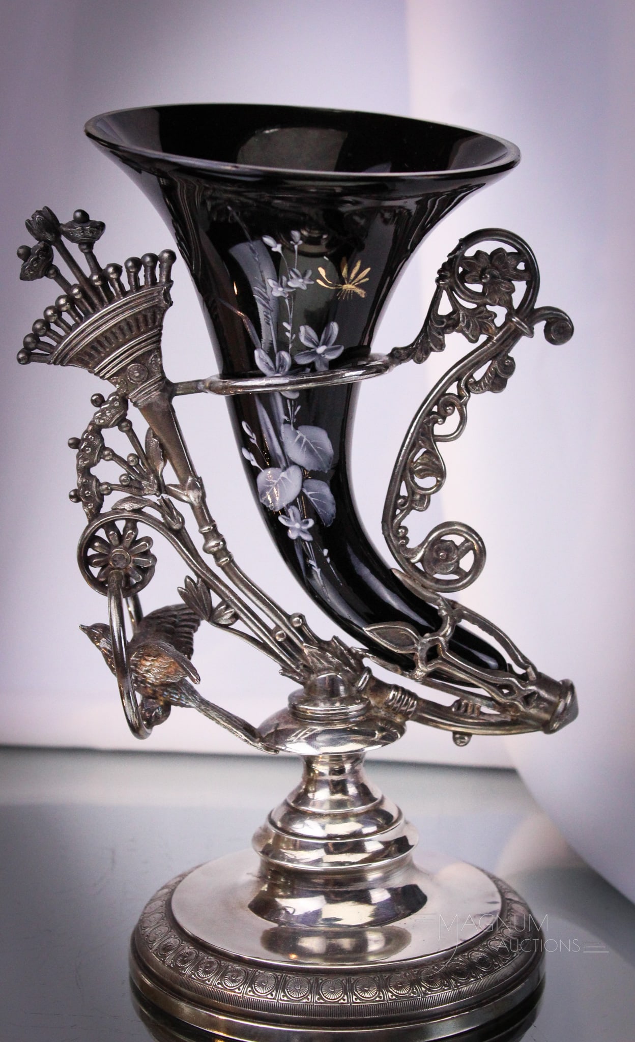 Victorian Rockford Silverplate Figural Cornucopia Enameled Glass Vase: Phenomenal find in this signed Rockford silverplate holder featuring a black glass enameled cornucopia vase. Holder is adorned with a bird. Piece measures 8 1/4" tall.
