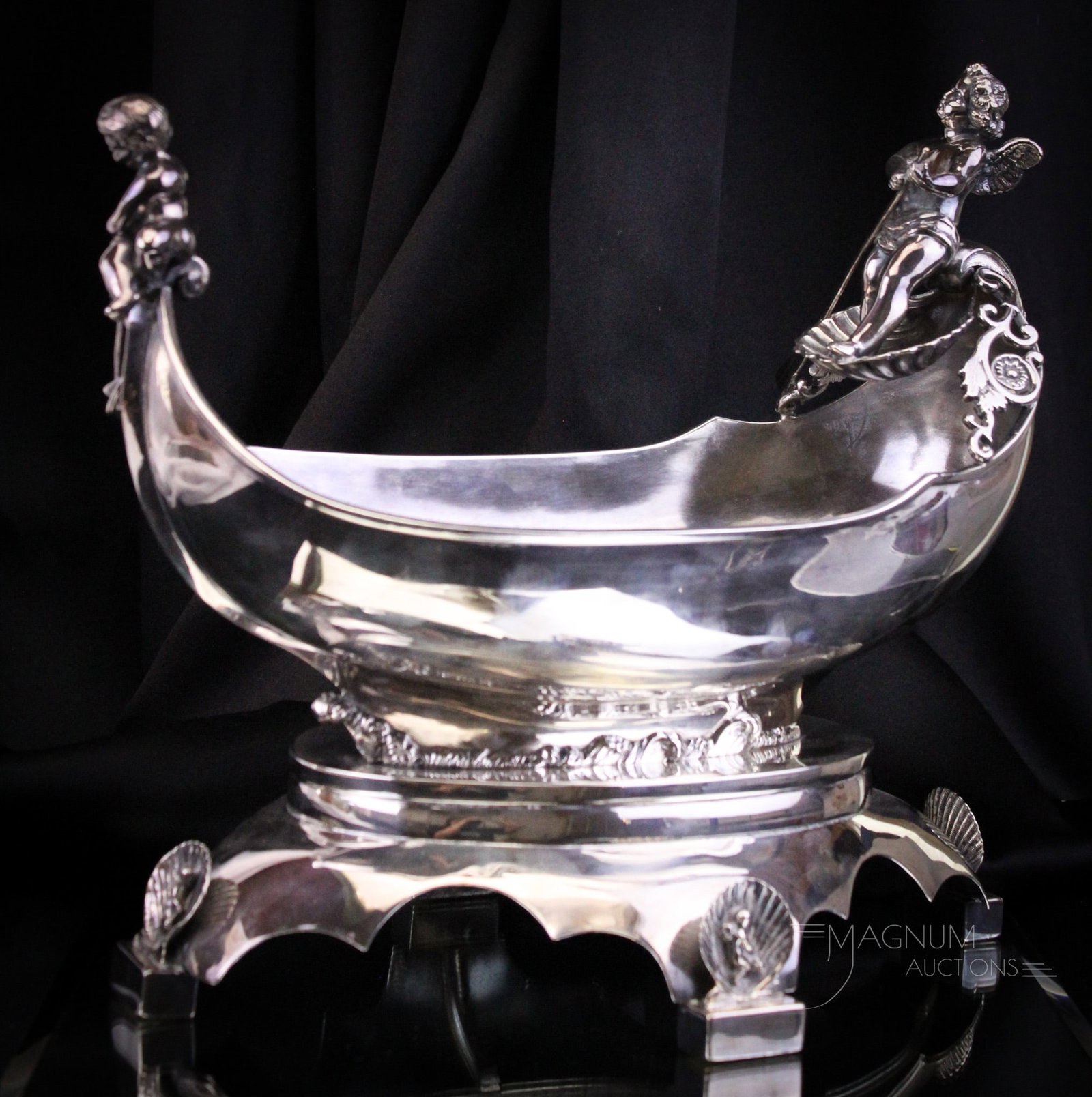 Victorian Silverplate Figural Gondola & Cherub Centerpiece: Beautiful Victorian silverplate figural gondola with cherubs atop. Piece measures 12" tall, 14" long.