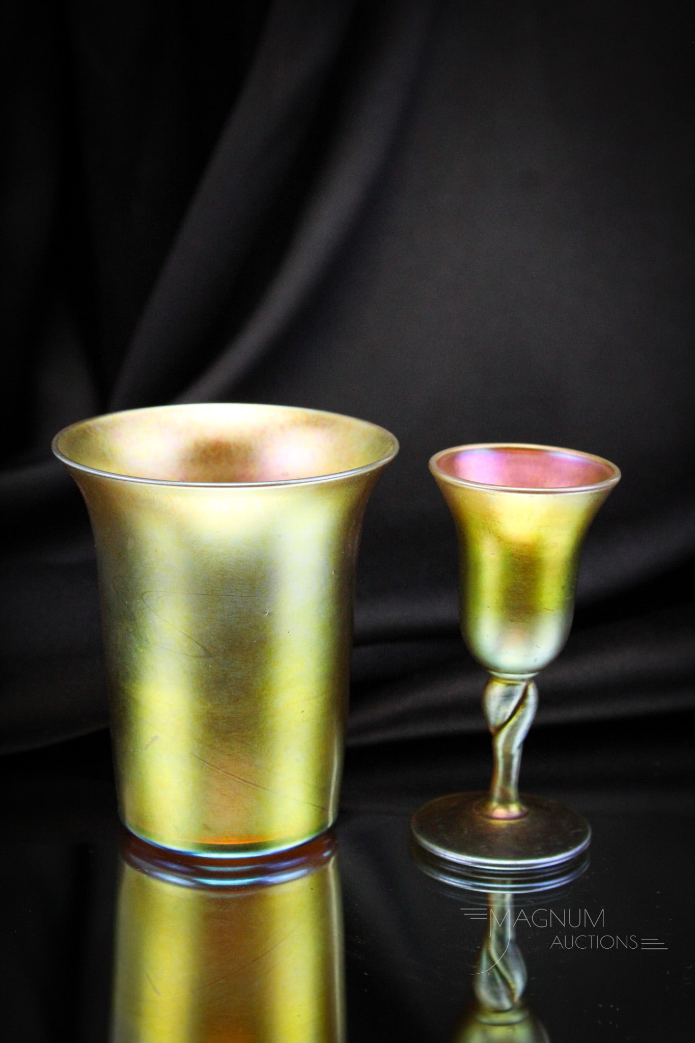 2 pc Lot Steuben Gold Aurene Glass Tumbler & Twist Cordial: Two great examples of signed Steuben glass in this lot. A tumbler along with a twist stem cordial. Tallest measures 3 3/4" tall. Provenance: This item is from the private collection of Bill & Betty S